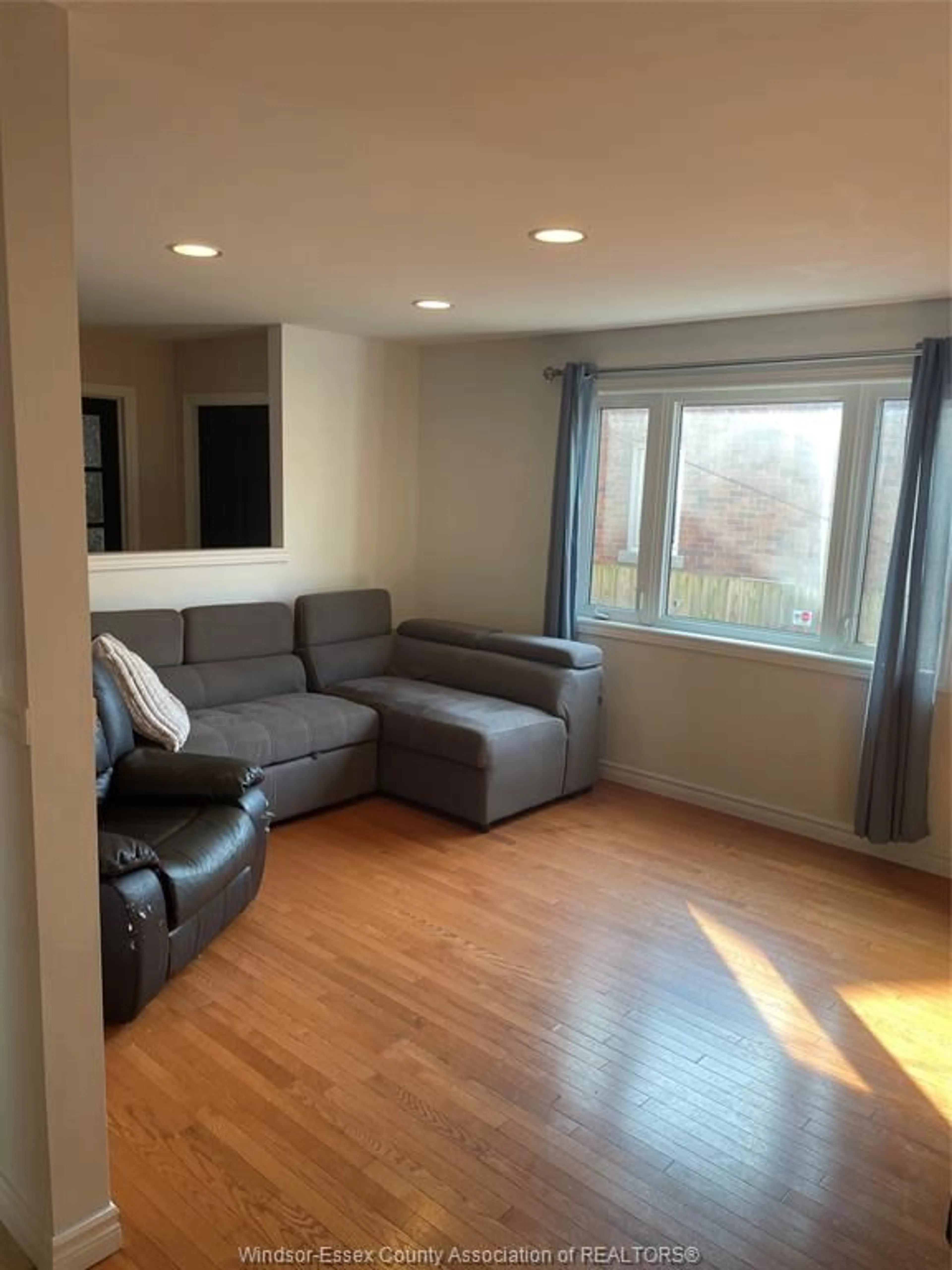 Living room with furniture, wood/laminate floor for 1833 ST . LUKE Rd, Windsor Ontario N8W 3W8