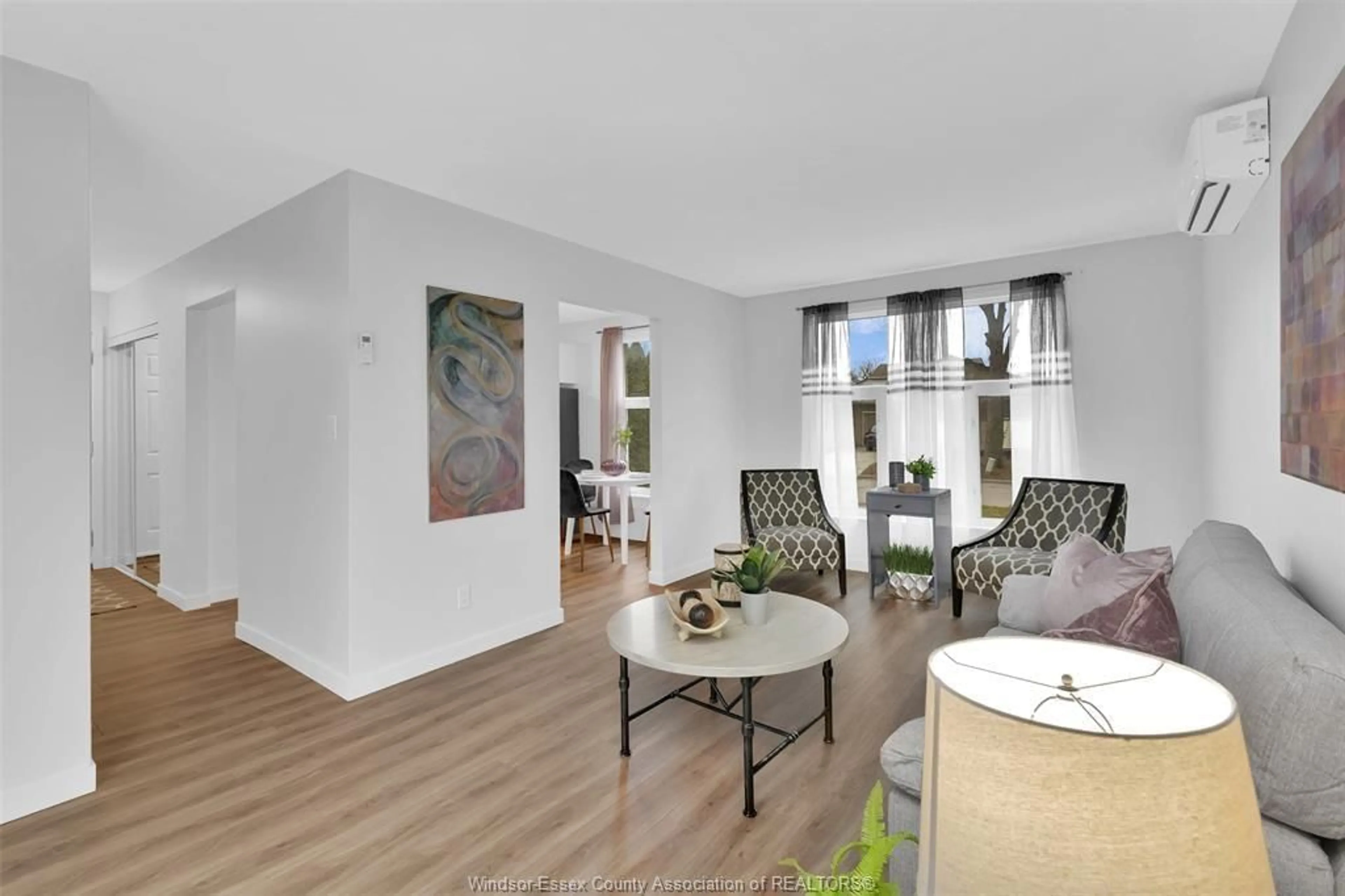 Living room with furniture, wood/laminate floor for 9260 ARNCLIFFE Crt, Windsor Ontario B8S 4J9