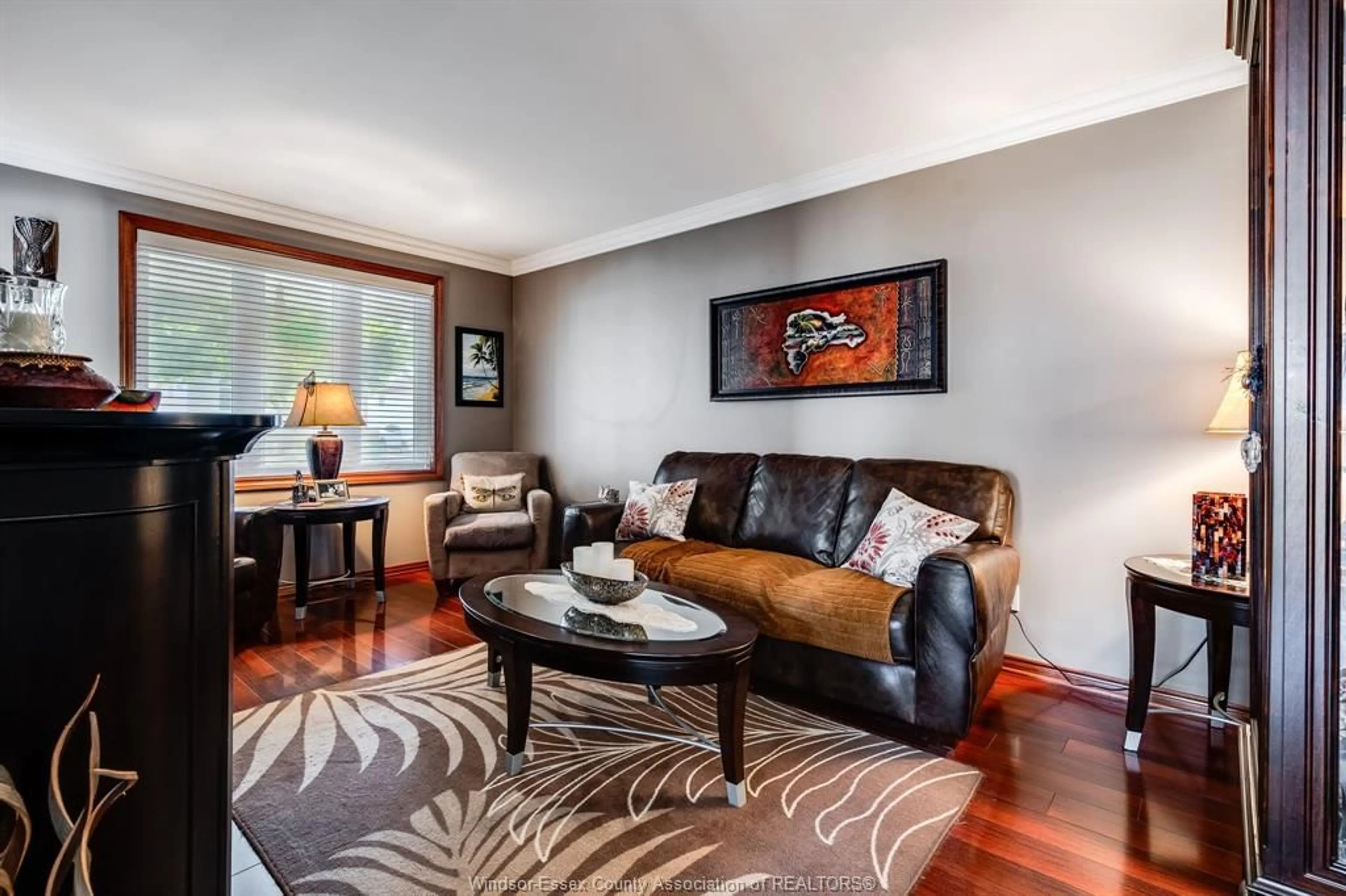 Living room with furniture, wood/laminate floor for 2677 Robert Rd, Windsor Ontario N8W 5L8