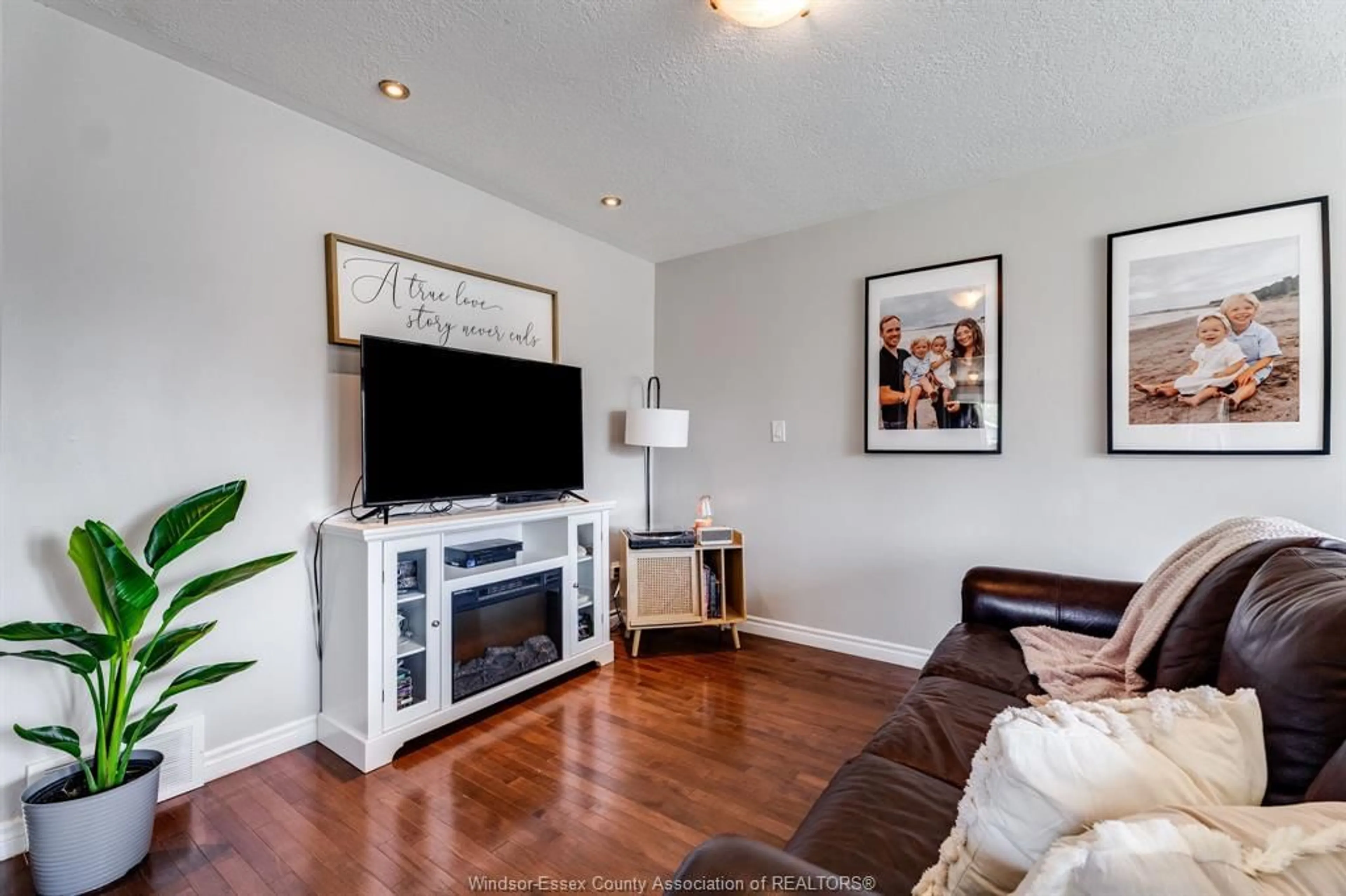 Living room with furniture, wood/laminate floor for 57 Marion Ave, Chatham Ontario N7M 5N7