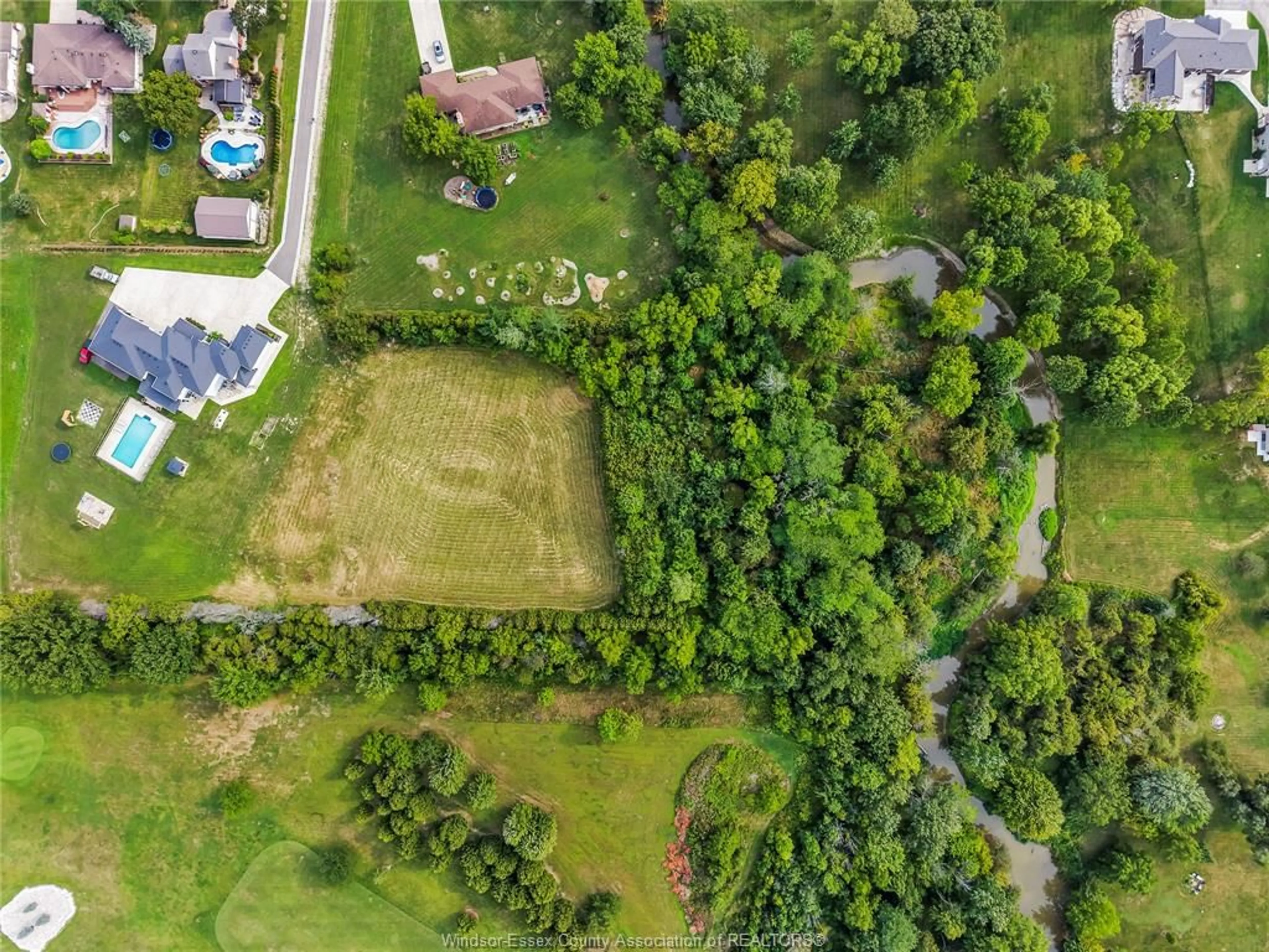A pic from outside/outdoor area/front of a property/back of a property/a pic from drone, forest/trees view for 57 BISSONNETTE Lane, Lakeshore Ontario N0R 1V0