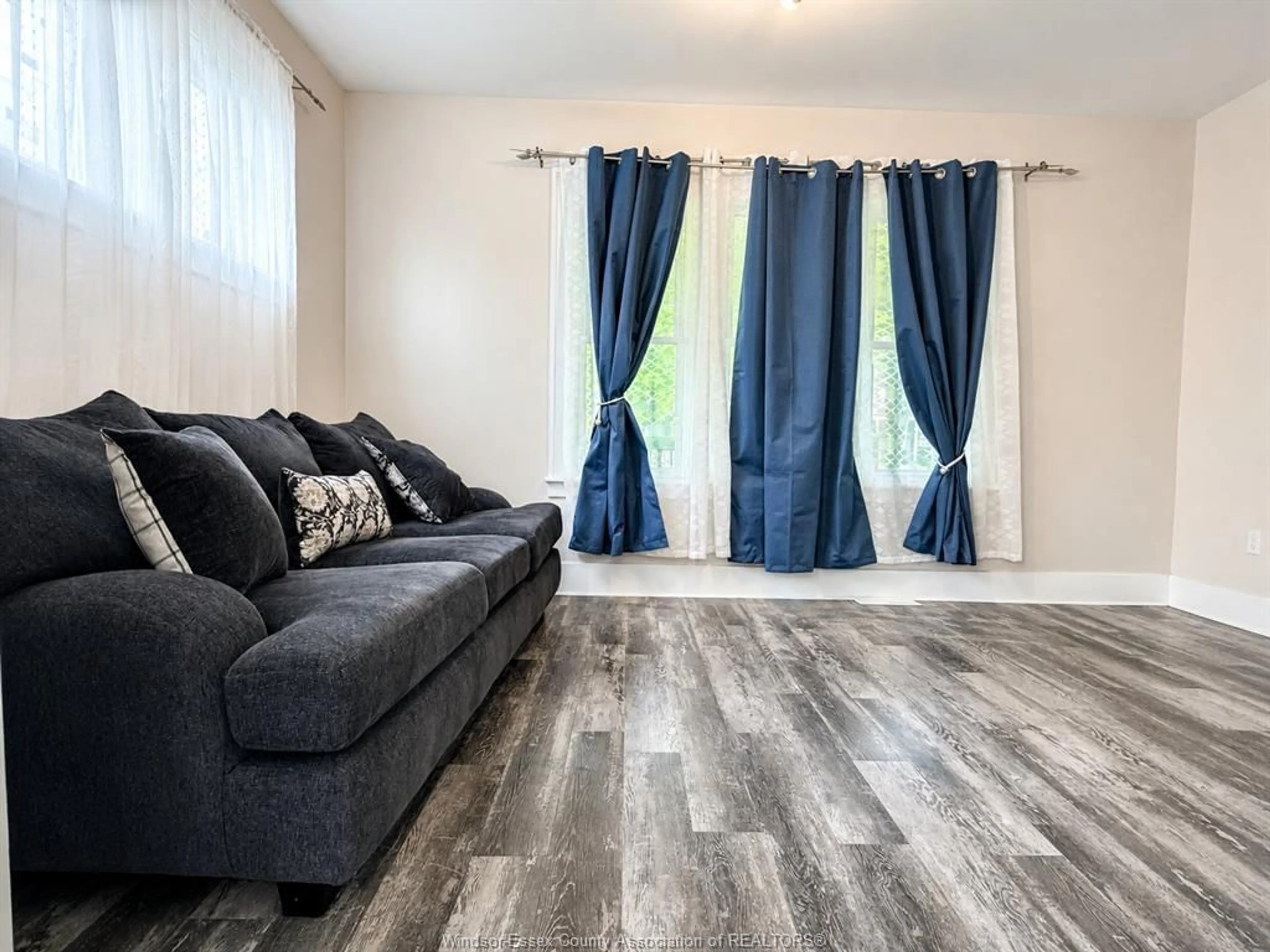 Living room with furniture, wood/laminate floor for 1585 CHURCH St, Windsor Ontario N8X 1V4