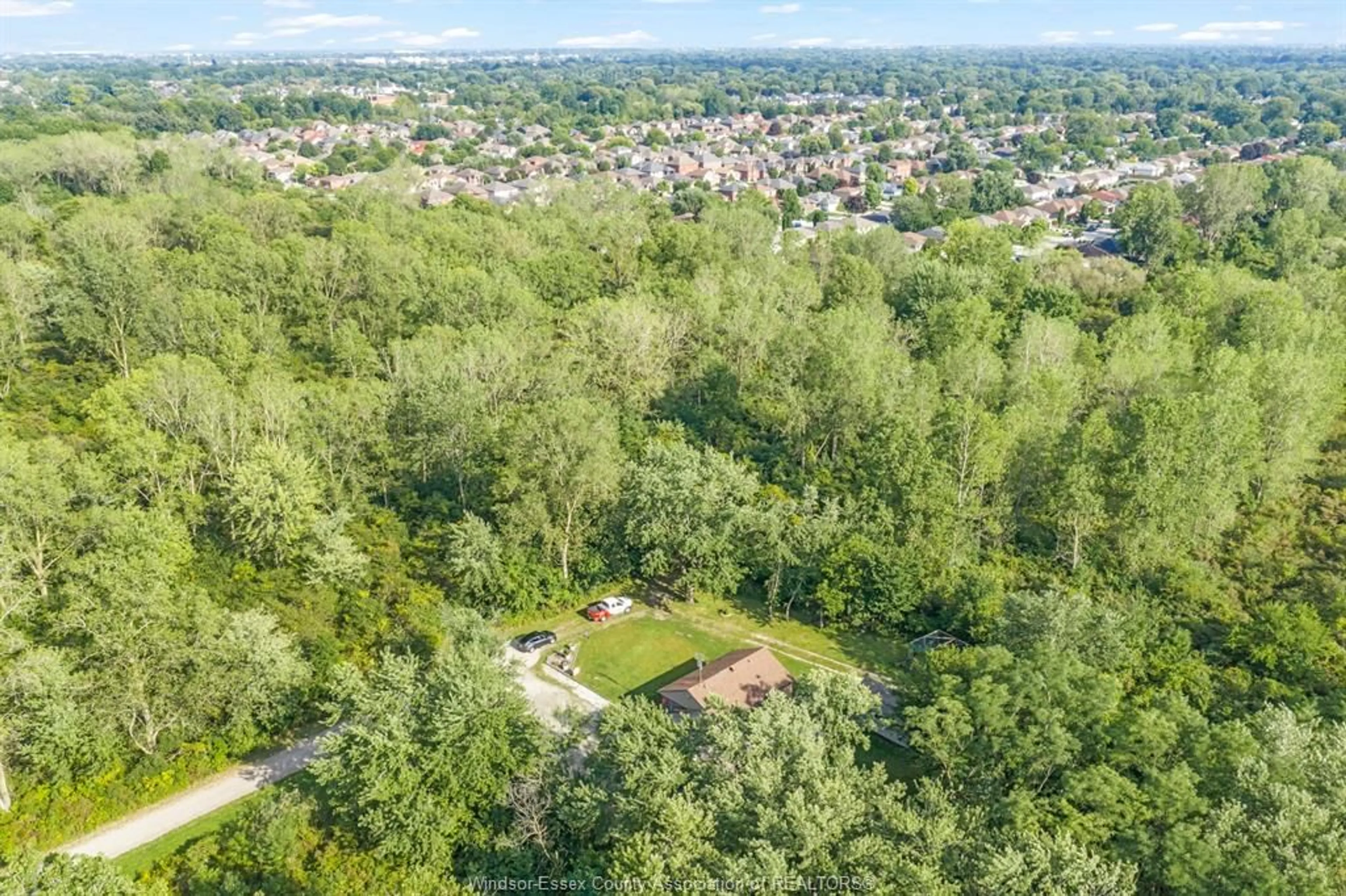 A pic from outside/outdoor area/front of a property/back of a property/a pic from drone, forest/trees view for 2125 Betts, Windsor Ontario N9B 3P5