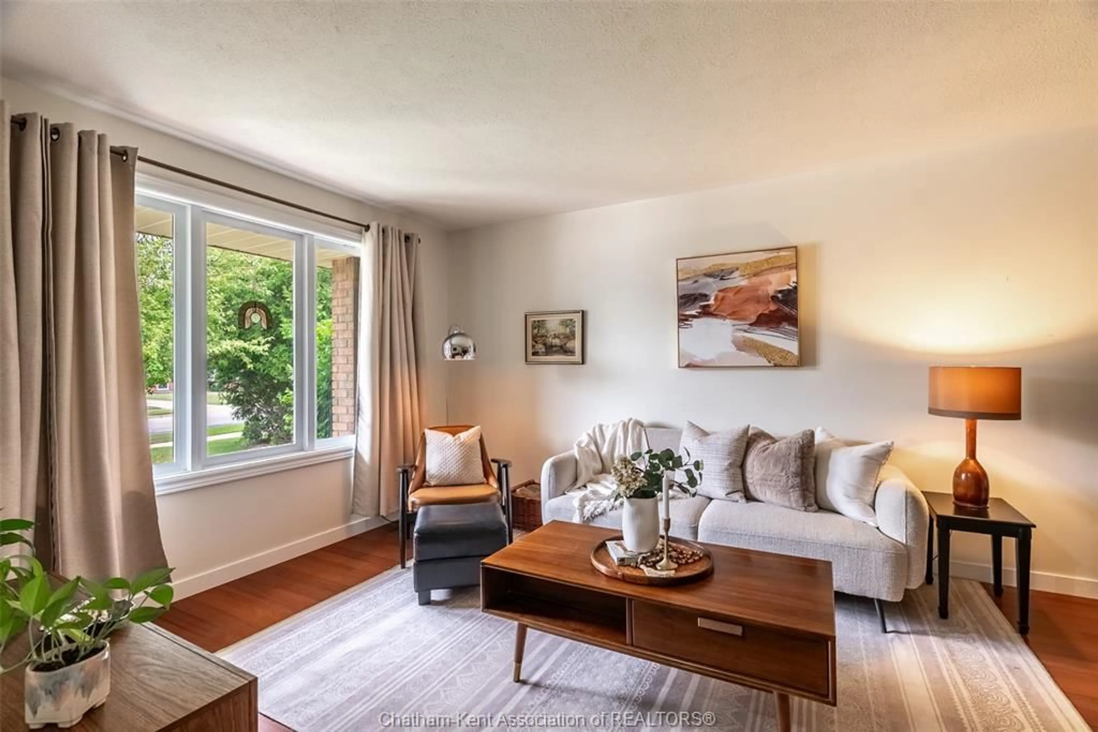 Living room with furniture, wood/laminate floor for 413 Baldoon Rd, Chatham Ontario N7L 5H2