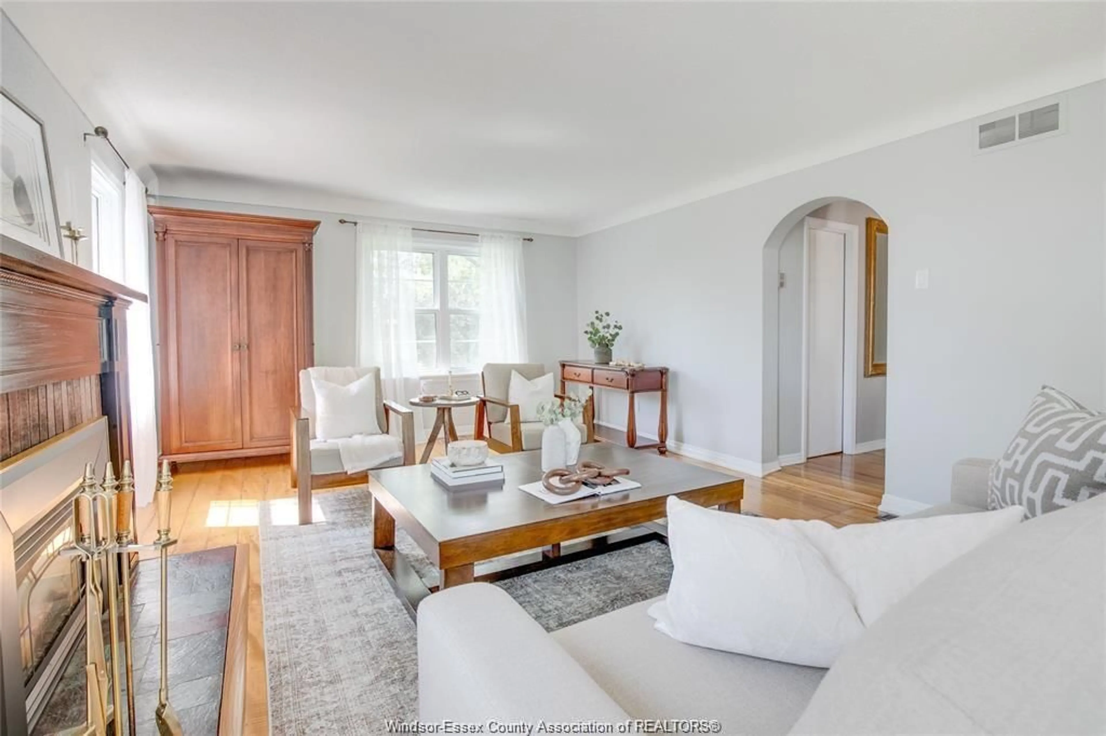 Living room with furniture, wood/laminate floor for 6239 HOLDEN Rd, Tecumseh Ontario N0R 1L0