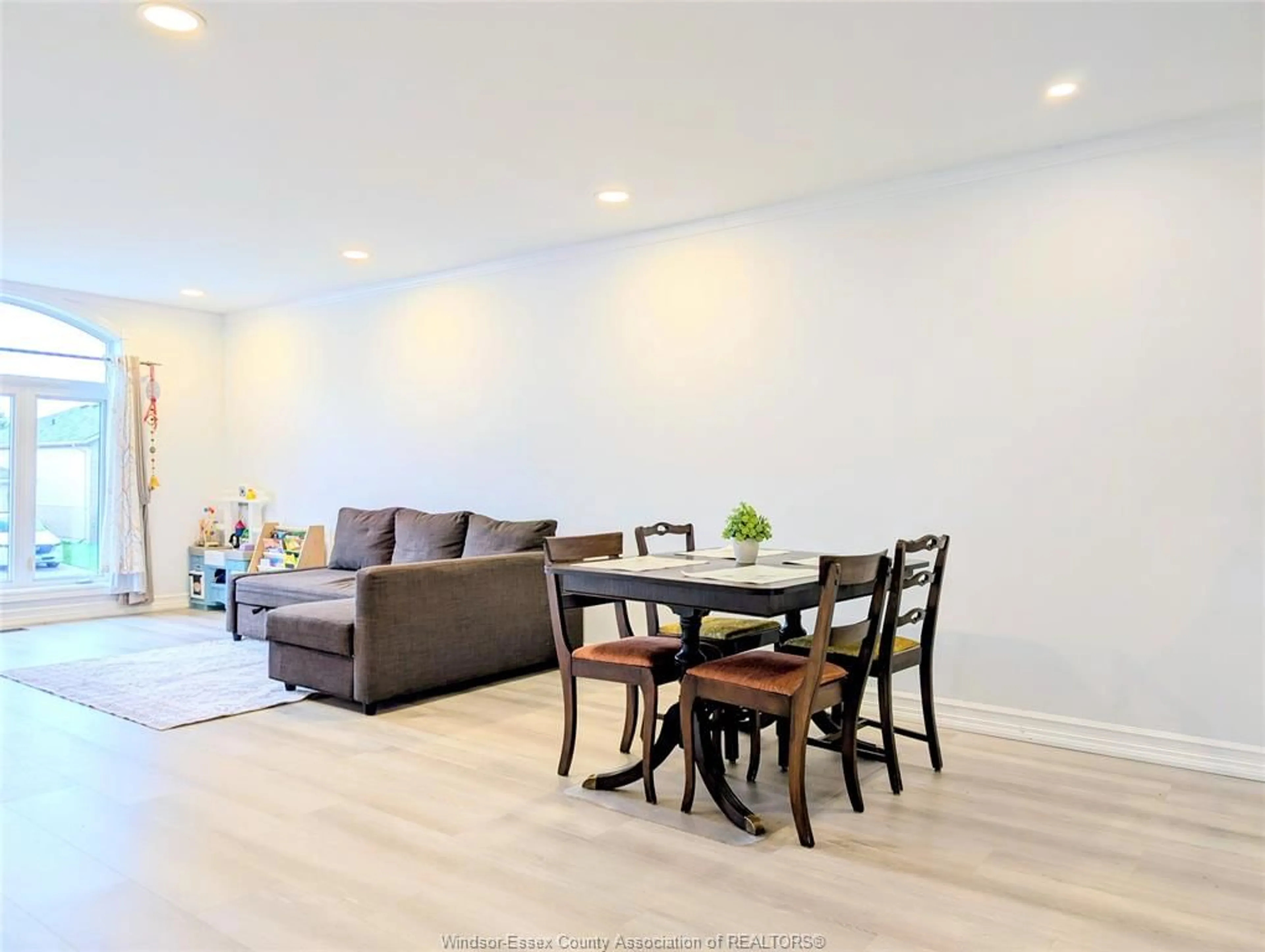 Living room with furniture, wood/laminate floor for 4465 SPAGO Cres, Windsor Ontario N9G 2Z6