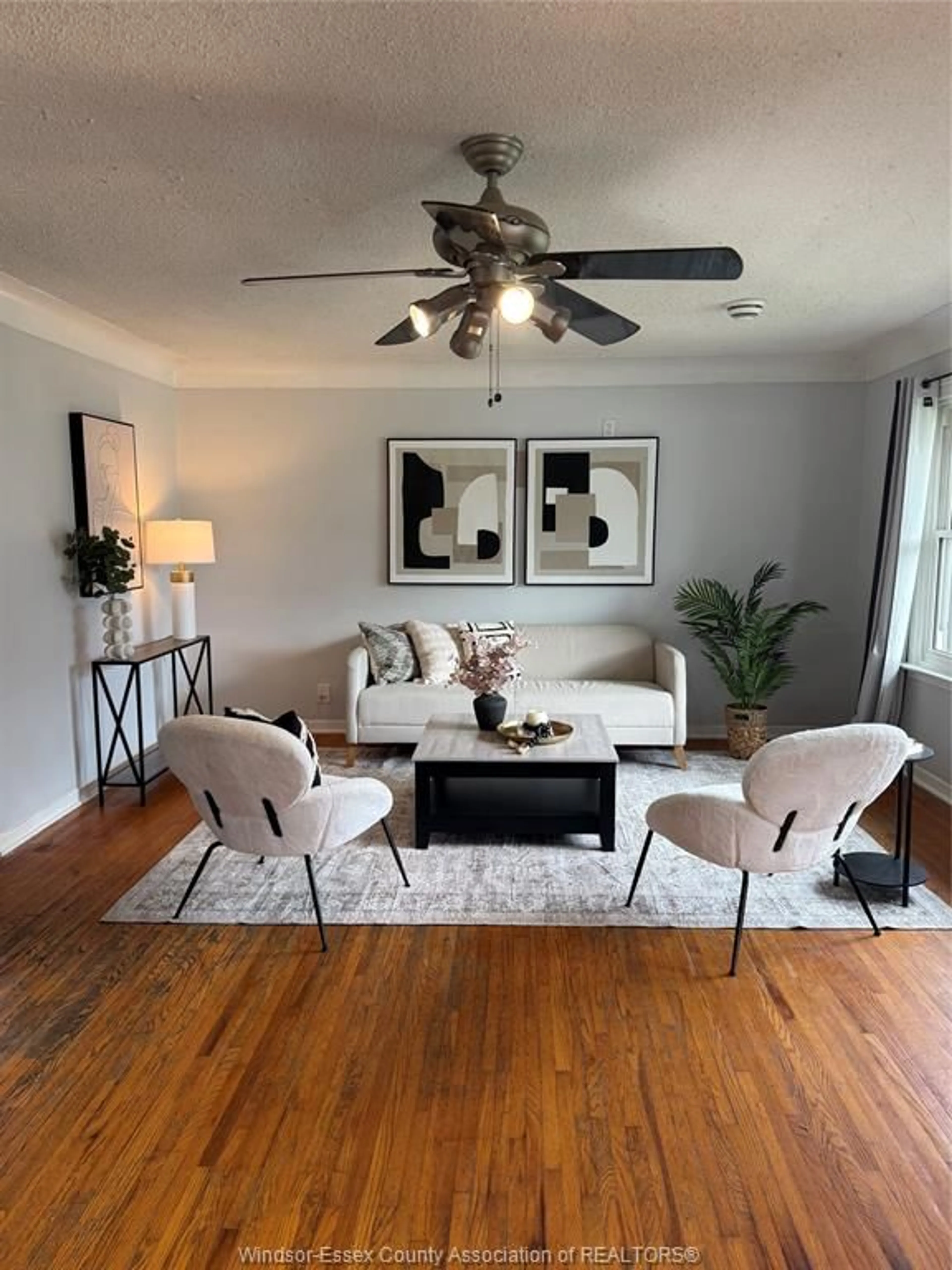 Living room with furniture, wood/laminate floor for 401 St. Louis St., Belle River Ontario N0R 1A0
