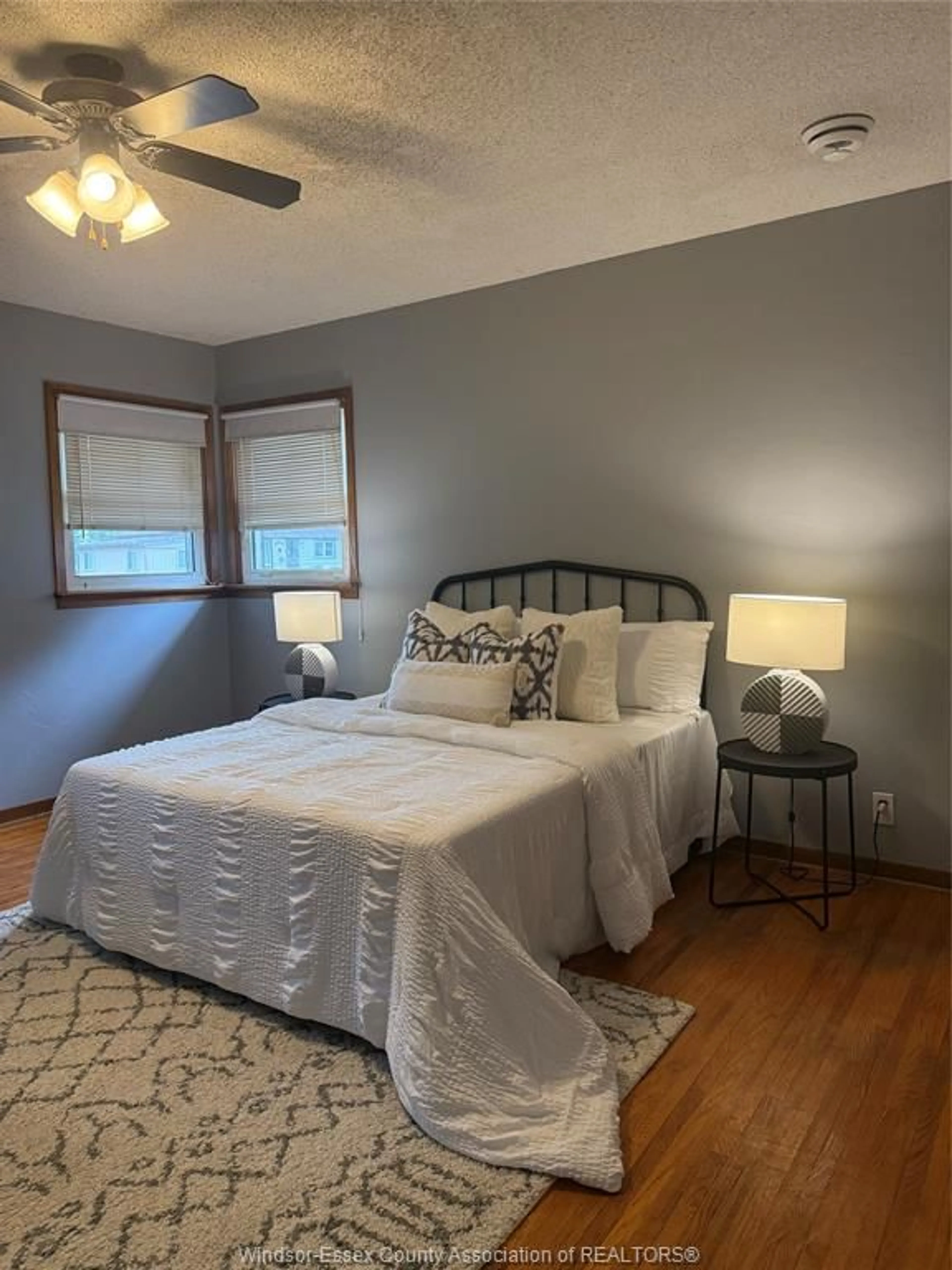 Bedroom with bed, wood/laminate floor for 401 St. Louis St., Belle River Ontario N0R 1A0