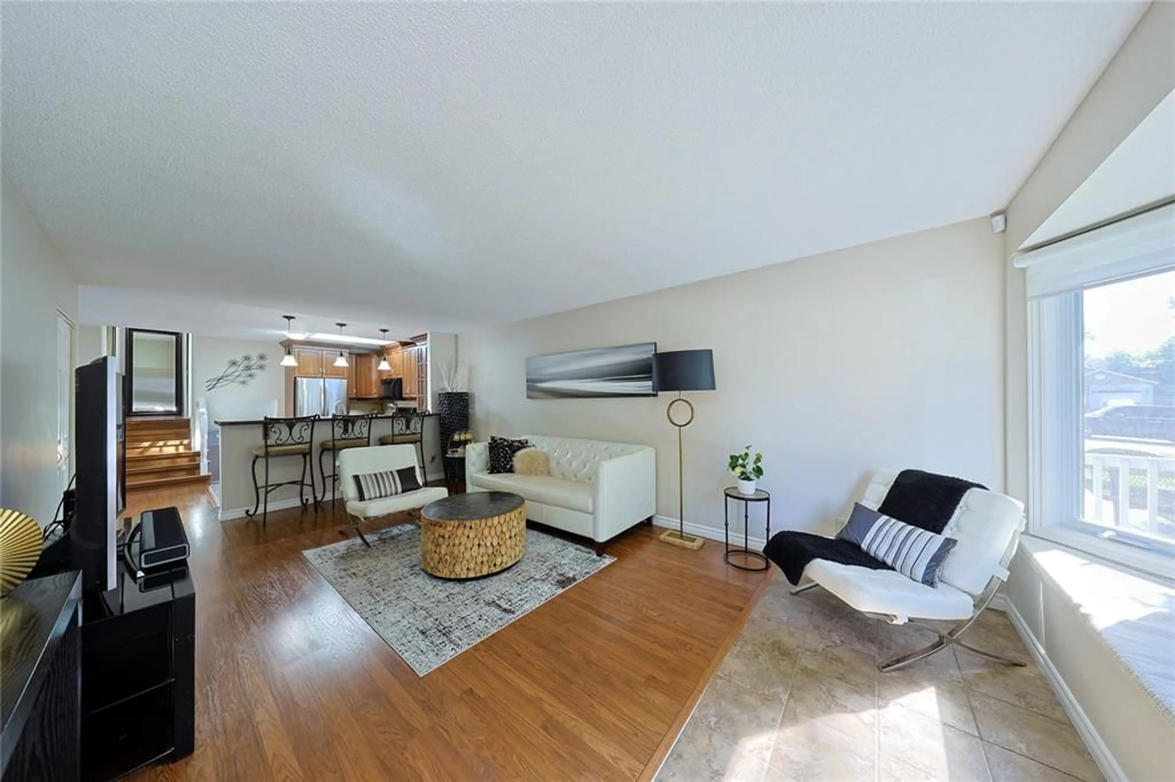Living room with furniture, wood/laminate floor for 1234 Thistledown Ave, Sarnia Ontario N7S 5A9