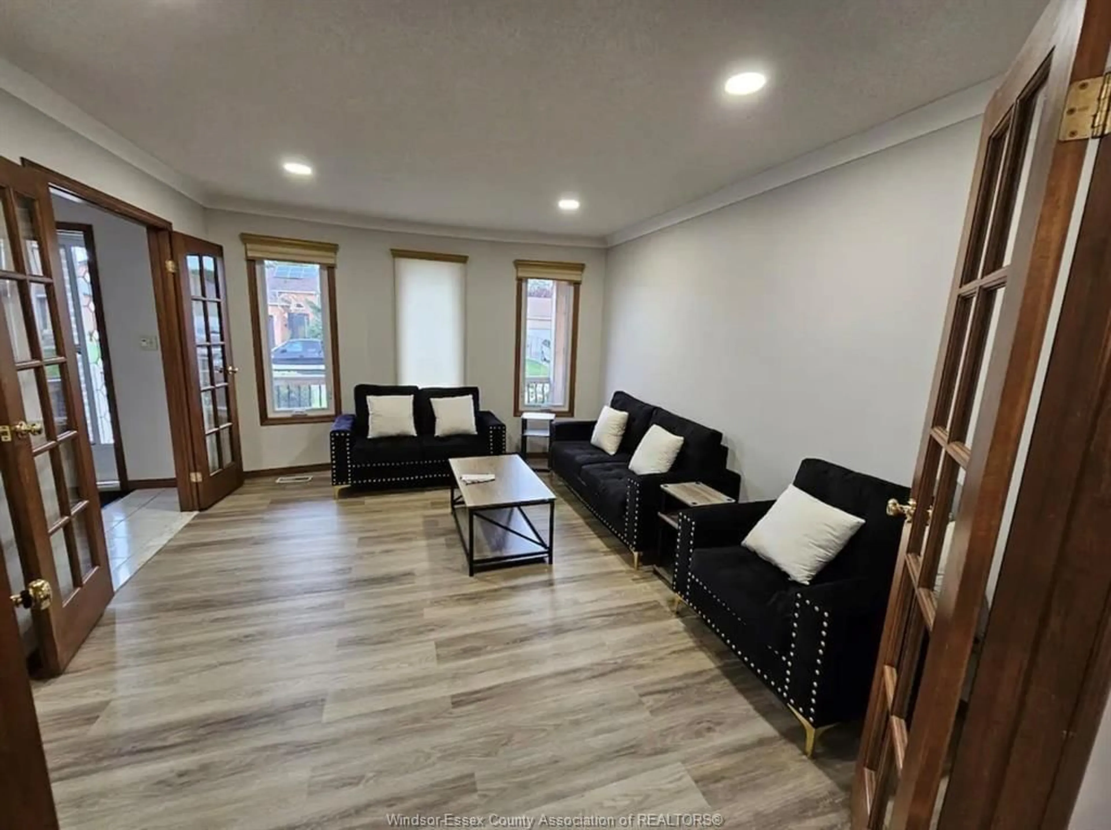 Living room with furniture, wood/laminate floor for 1237 KENWICK Way, LaSalle Ontario N9H 2G6