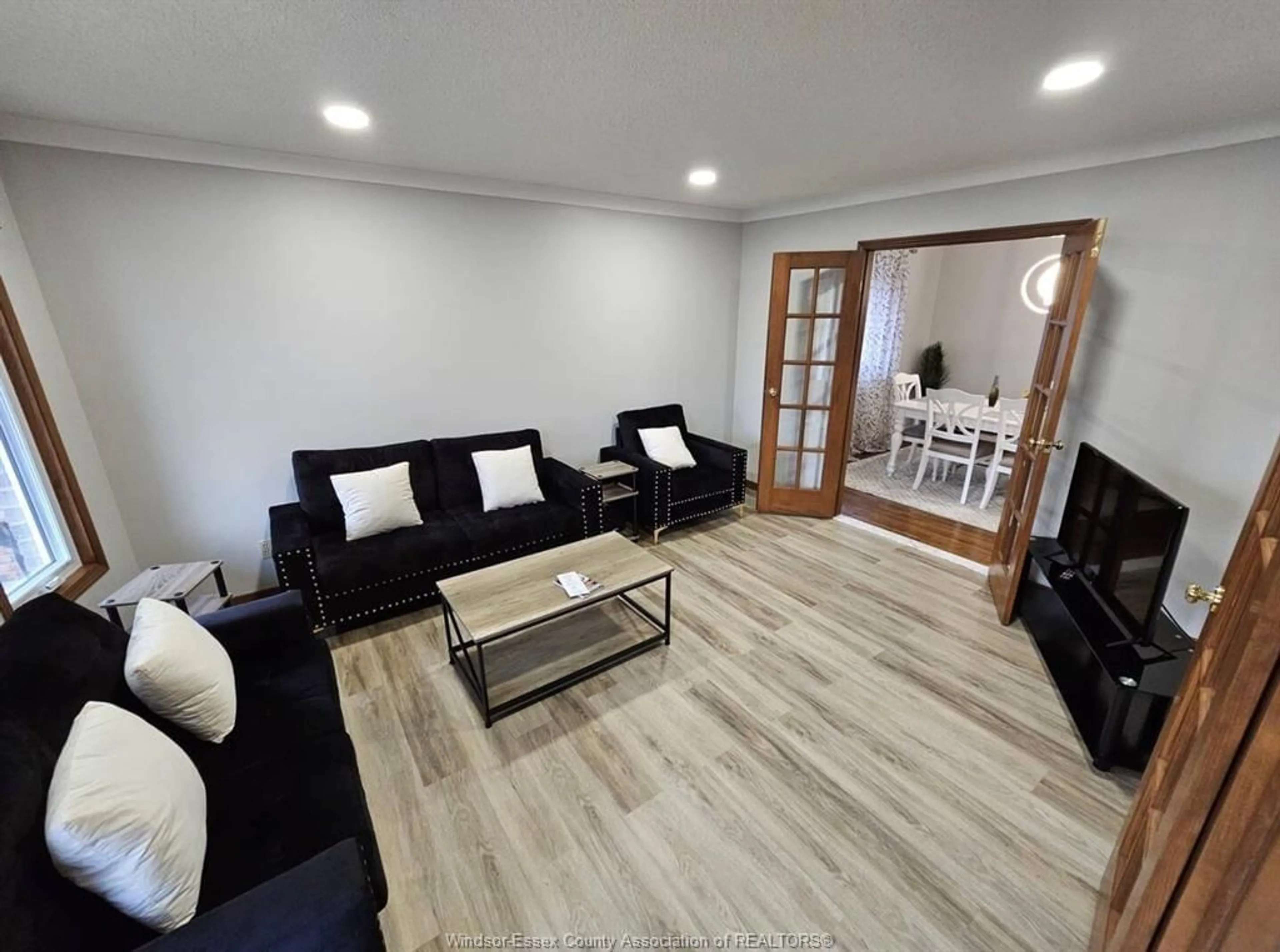 Living room with furniture, wood/laminate floor for 1237 KENWICK Way, LaSalle Ontario N9H 2G6