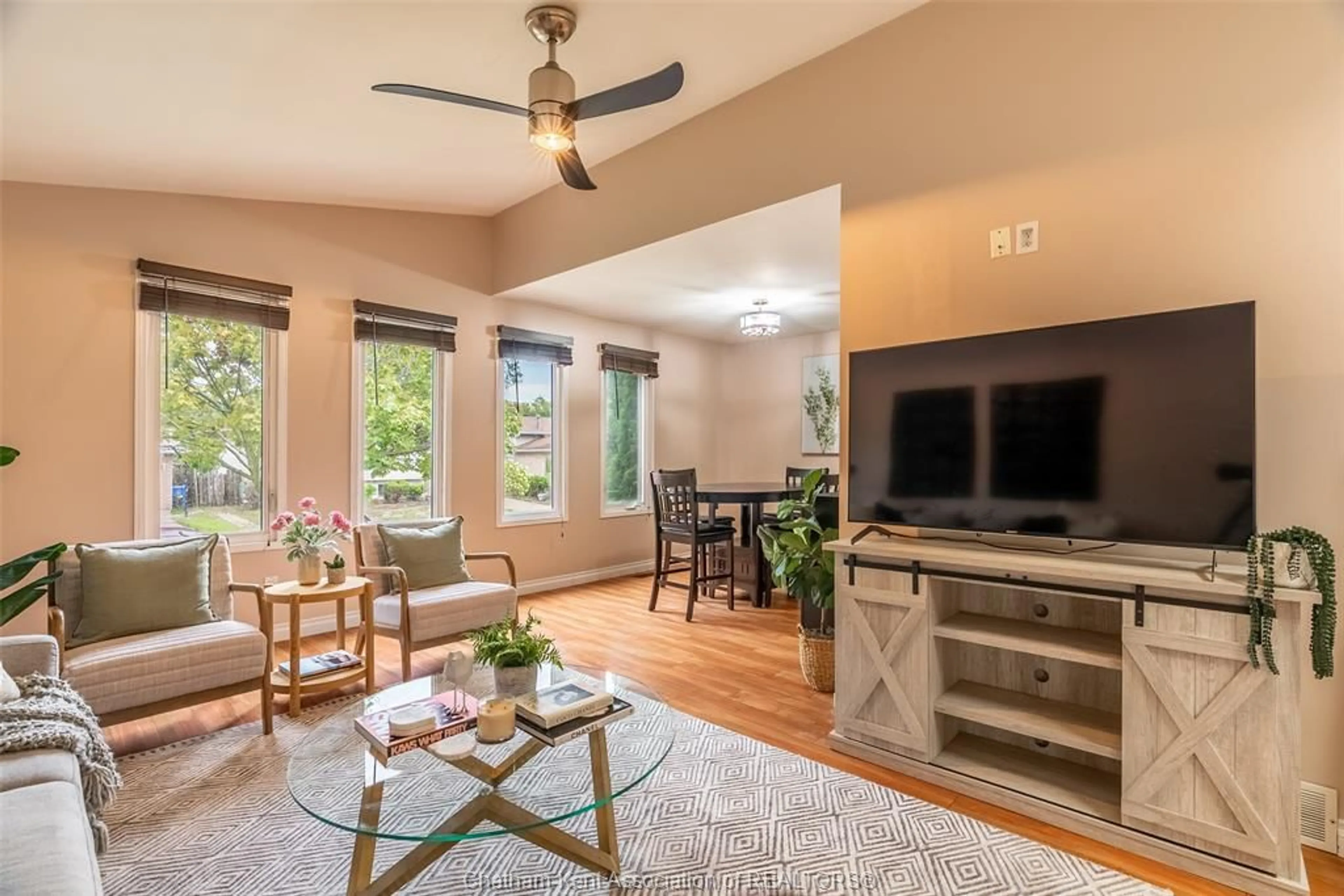 Living room with furniture, wood/laminate floor for 9385 Tamarack St, Windsor Ontario N8R 1Y7