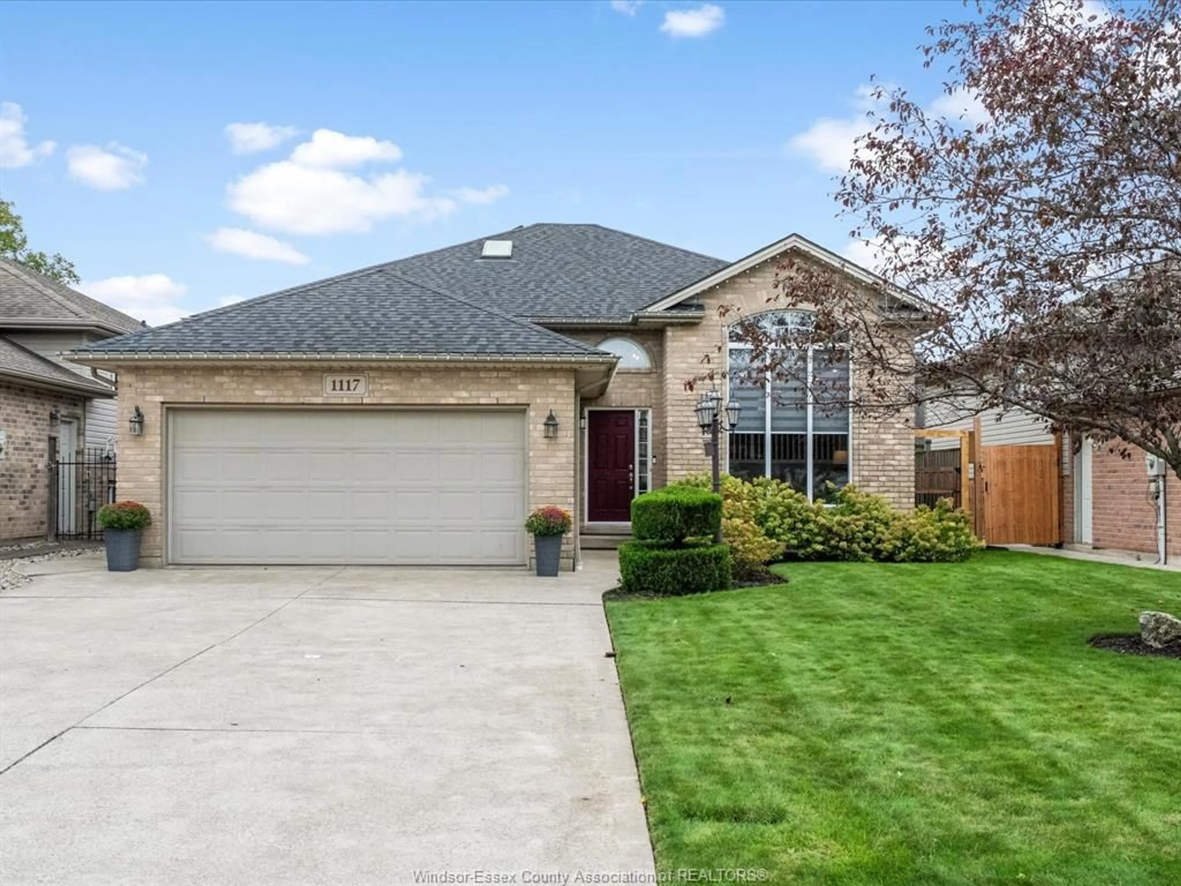 Home with brick exterior material, street for 1117 MONARCH MEADOWS Dr, Lakeshore Ontario N8L 0W5