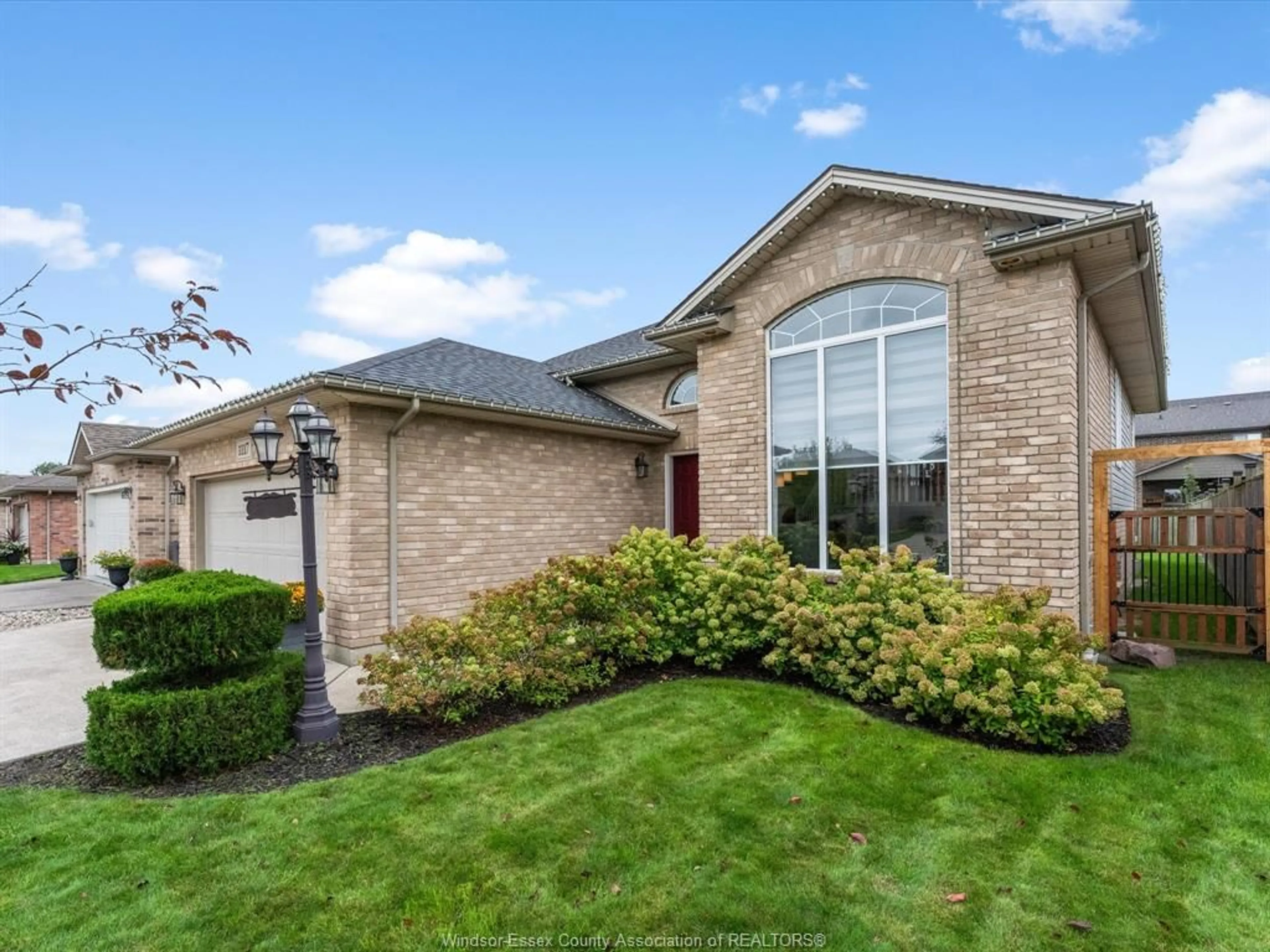 Home with brick exterior material, street for 1117 MONARCH MEADOWS Dr, Lakeshore Ontario N8L 0W5