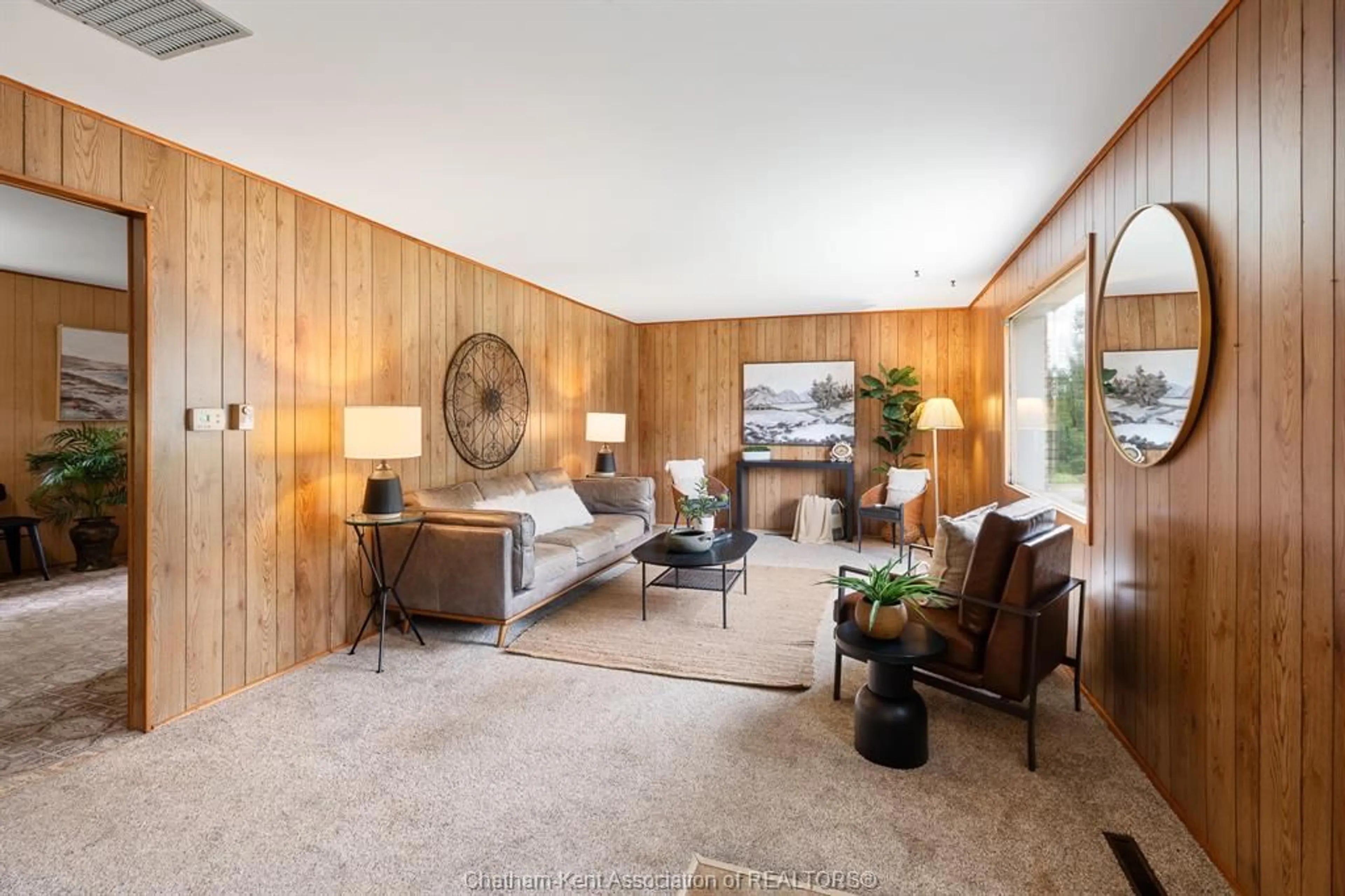 Living room with furniture, wood/laminate floor for 20725 Morris Rd, Tilbury North Ontario N0P 2L0
