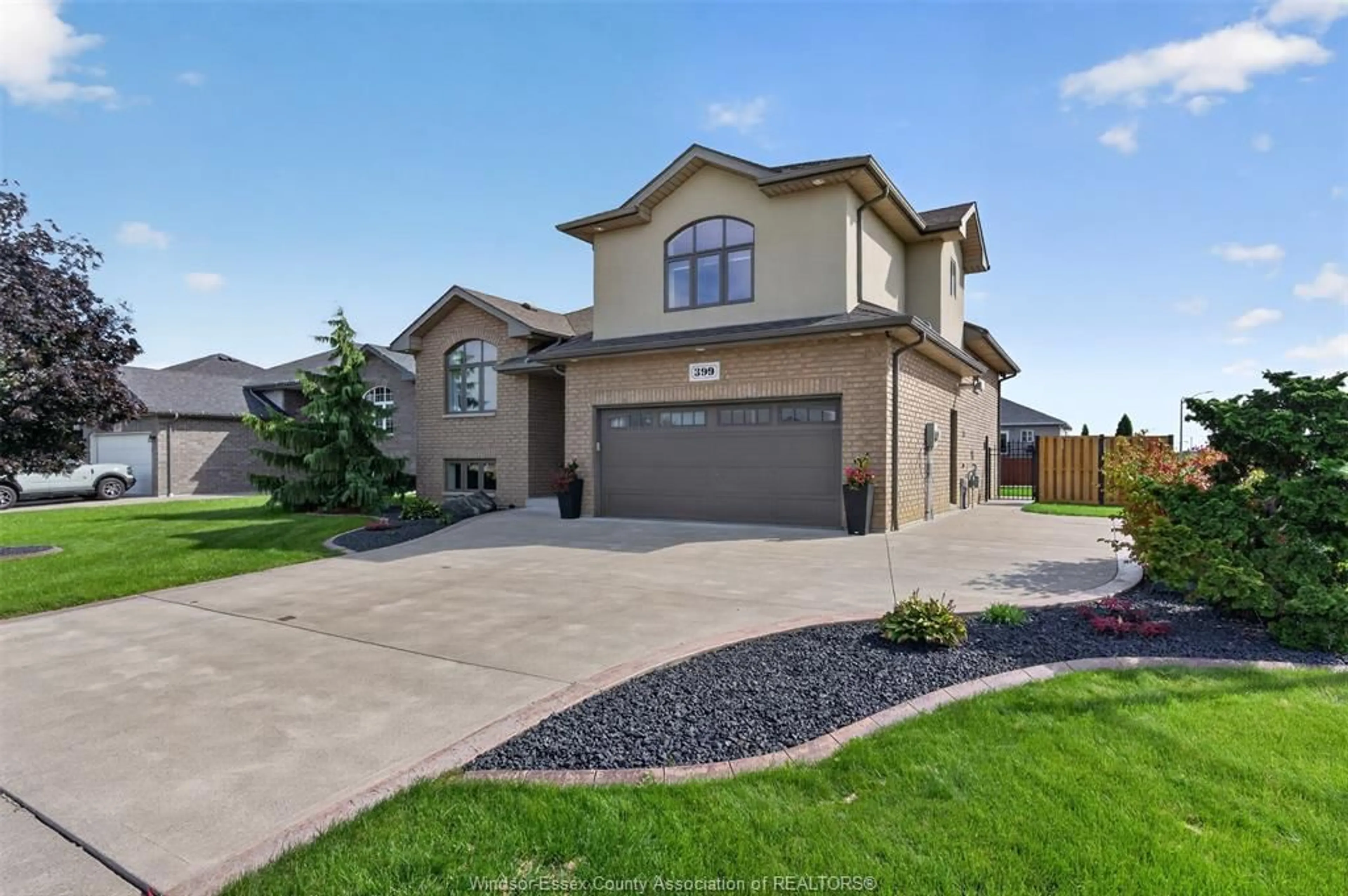 Home with brick exterior material, street for 399 POPLAR Dr, Lakeshore Ontario N8L 0X7