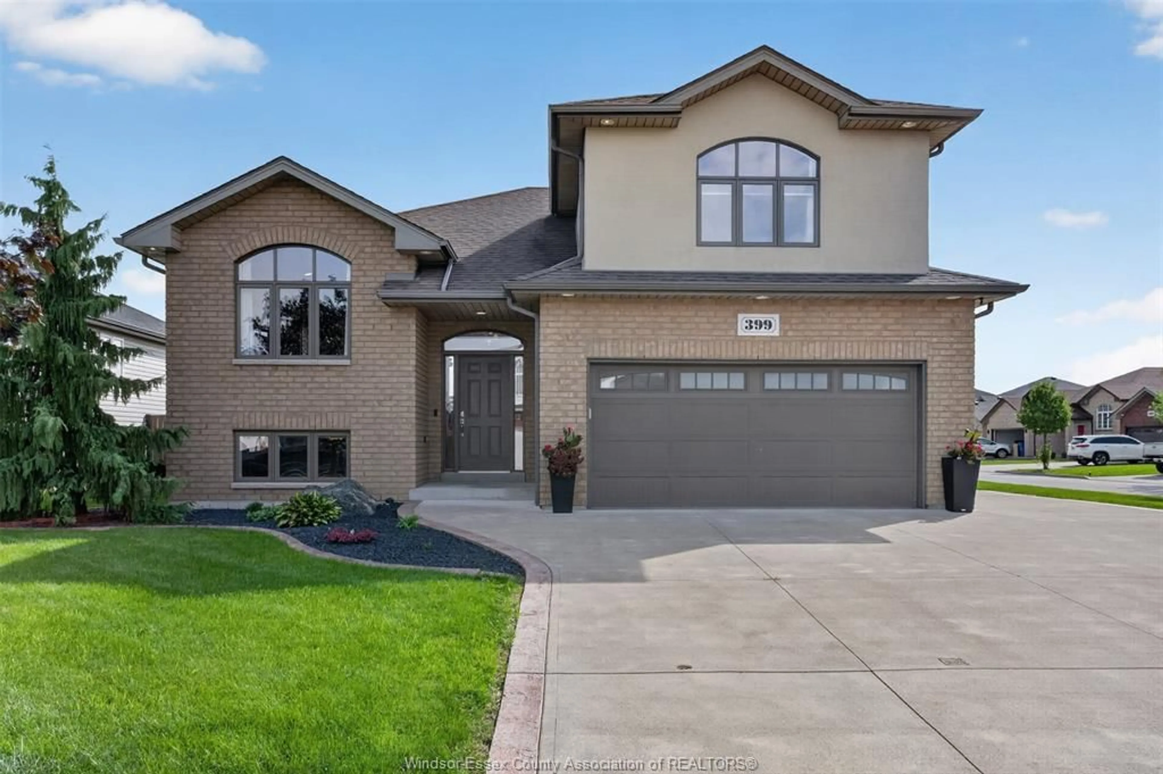 Home with brick exterior material, street for 399 POPLAR Dr, Lakeshore Ontario N8L 0X7