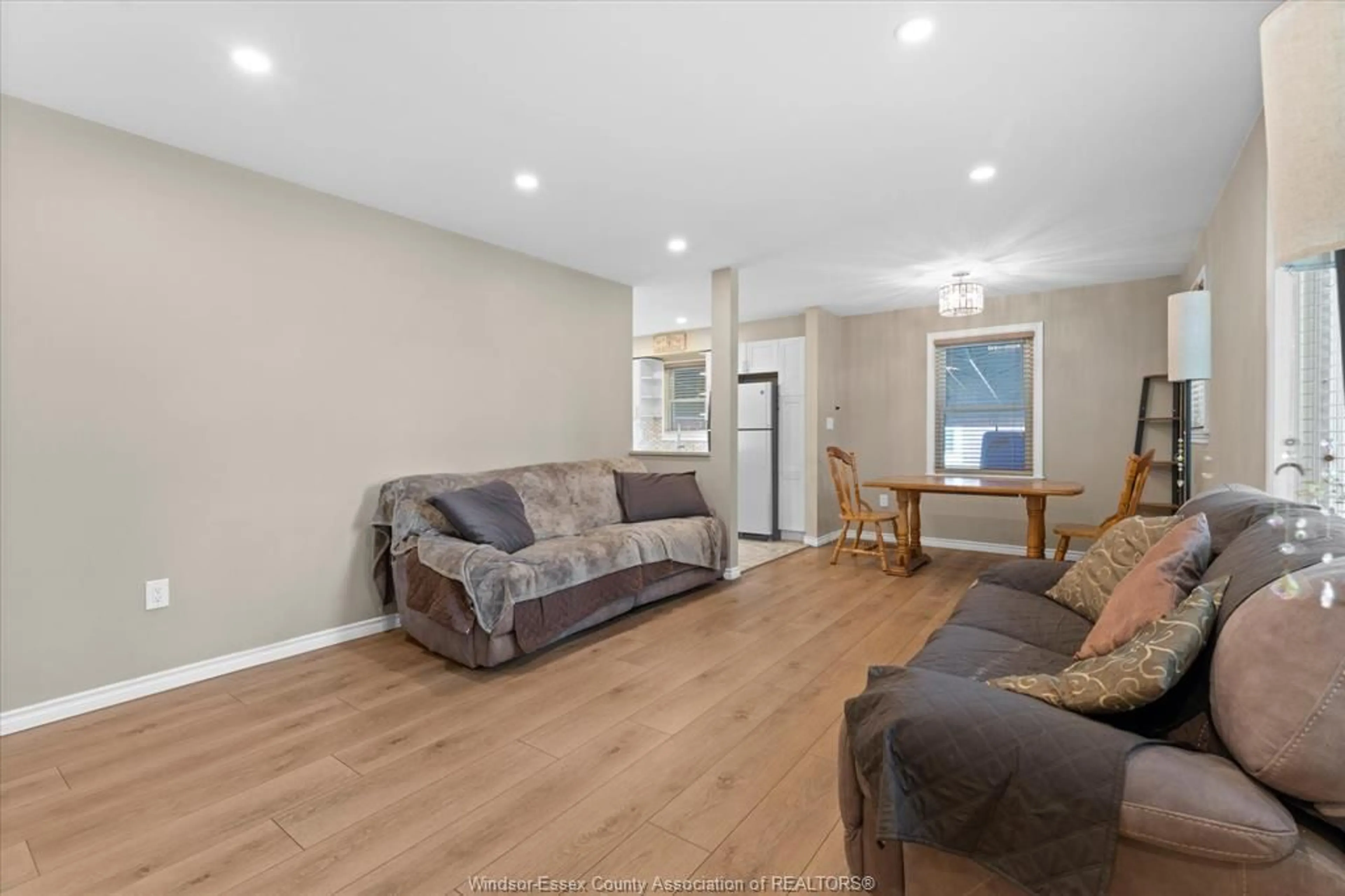 Living room with furniture, wood/laminate floor for 3163 Curry Ave, Windsor Ontario N9E 2T2