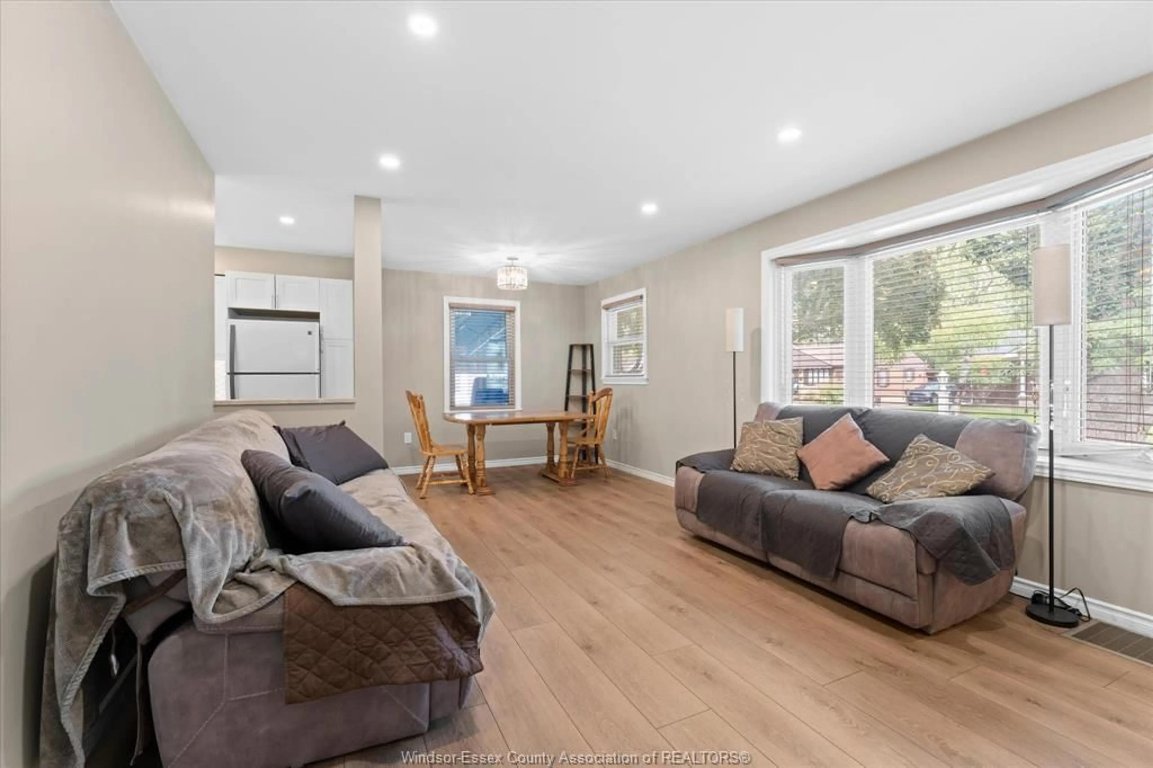 Living room with furniture, wood/laminate floor for 3163 Curry Ave, Windsor Ontario N9E 2T2