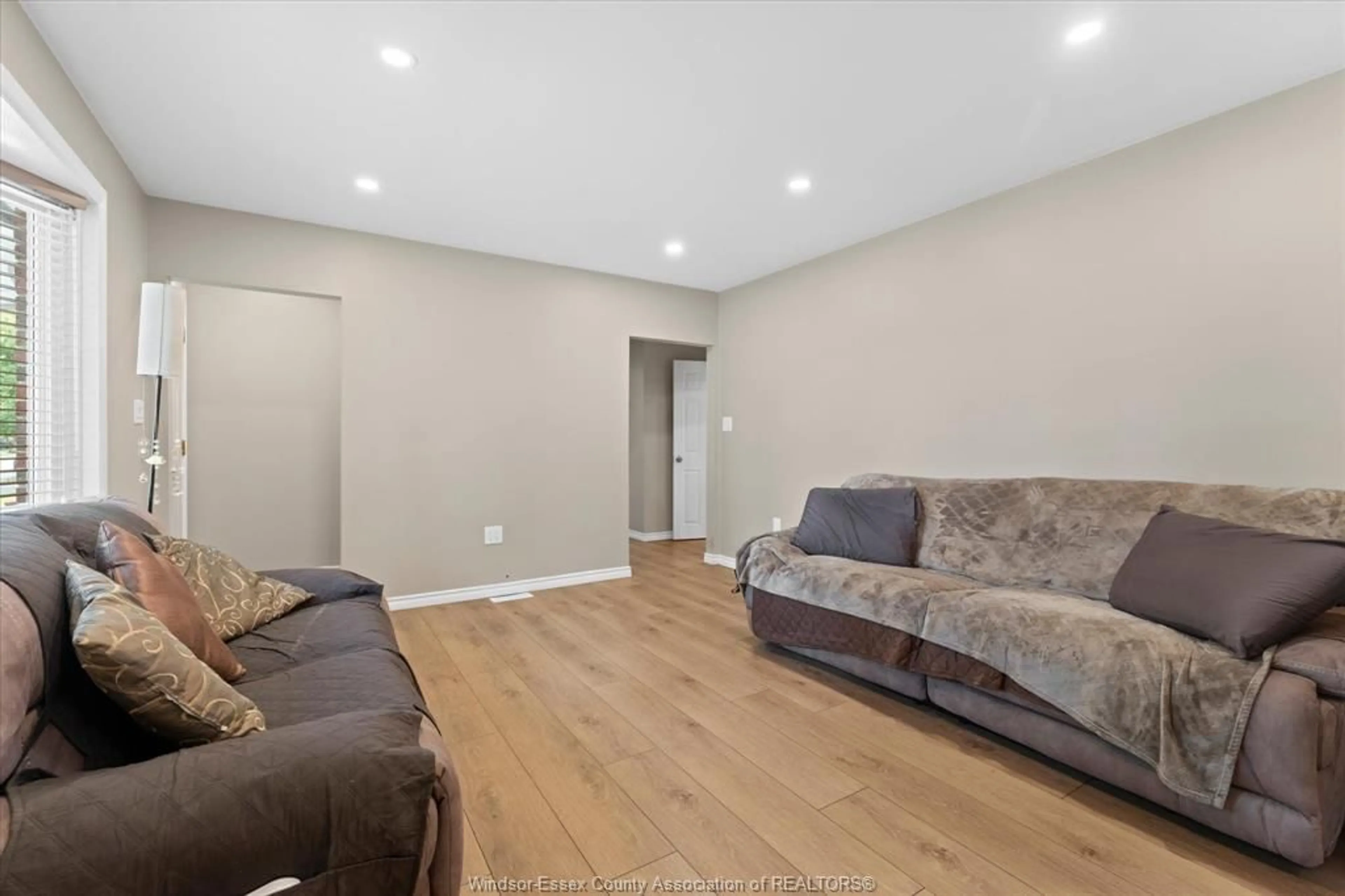 Living room with furniture, wood/laminate floor for 3163 Curry Ave, Windsor Ontario N9E 2T2