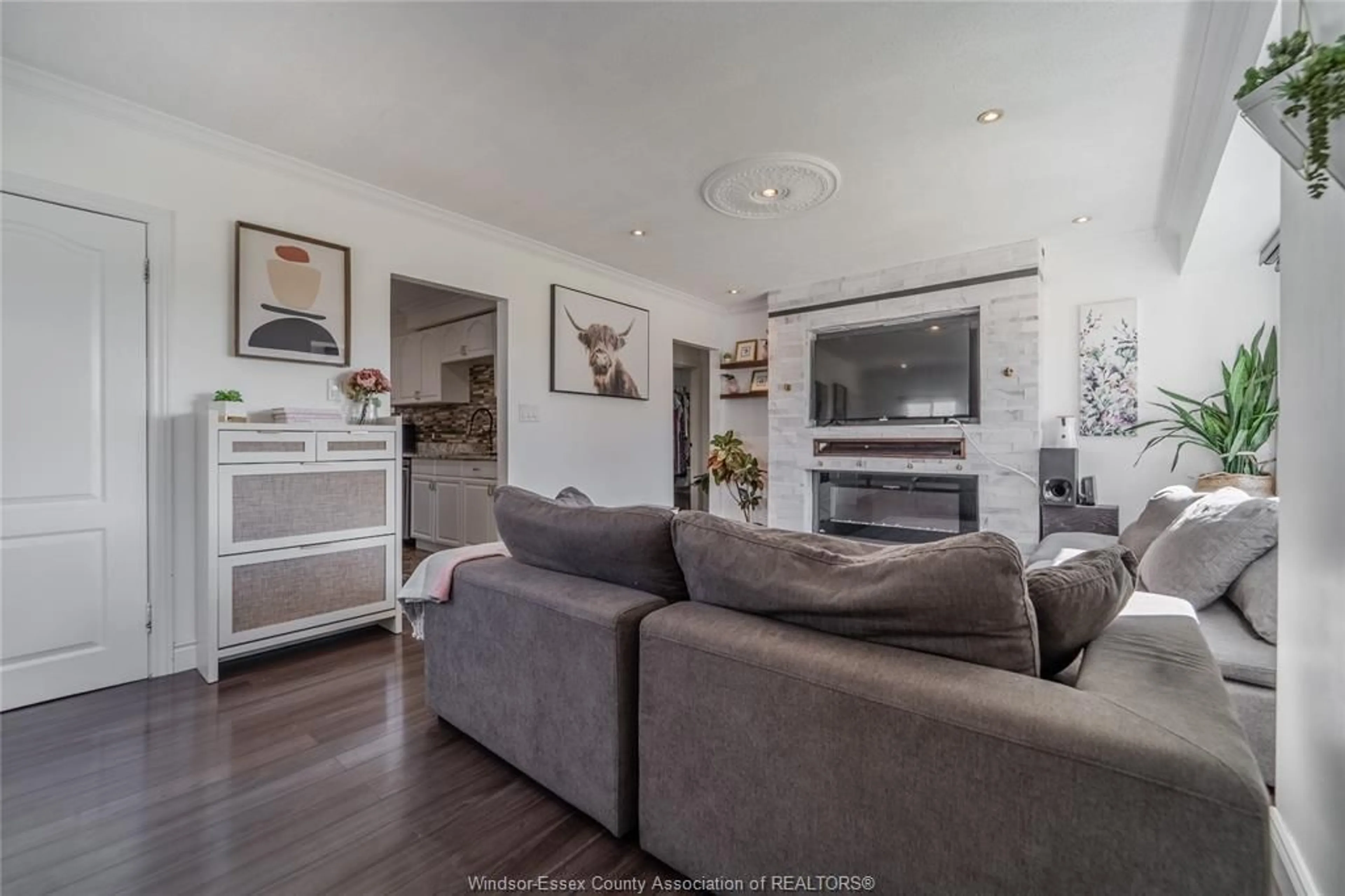 Living room with furniture, wood/laminate floor for 1838 Bernard Rd, Windsor Ontario N8W 4R4