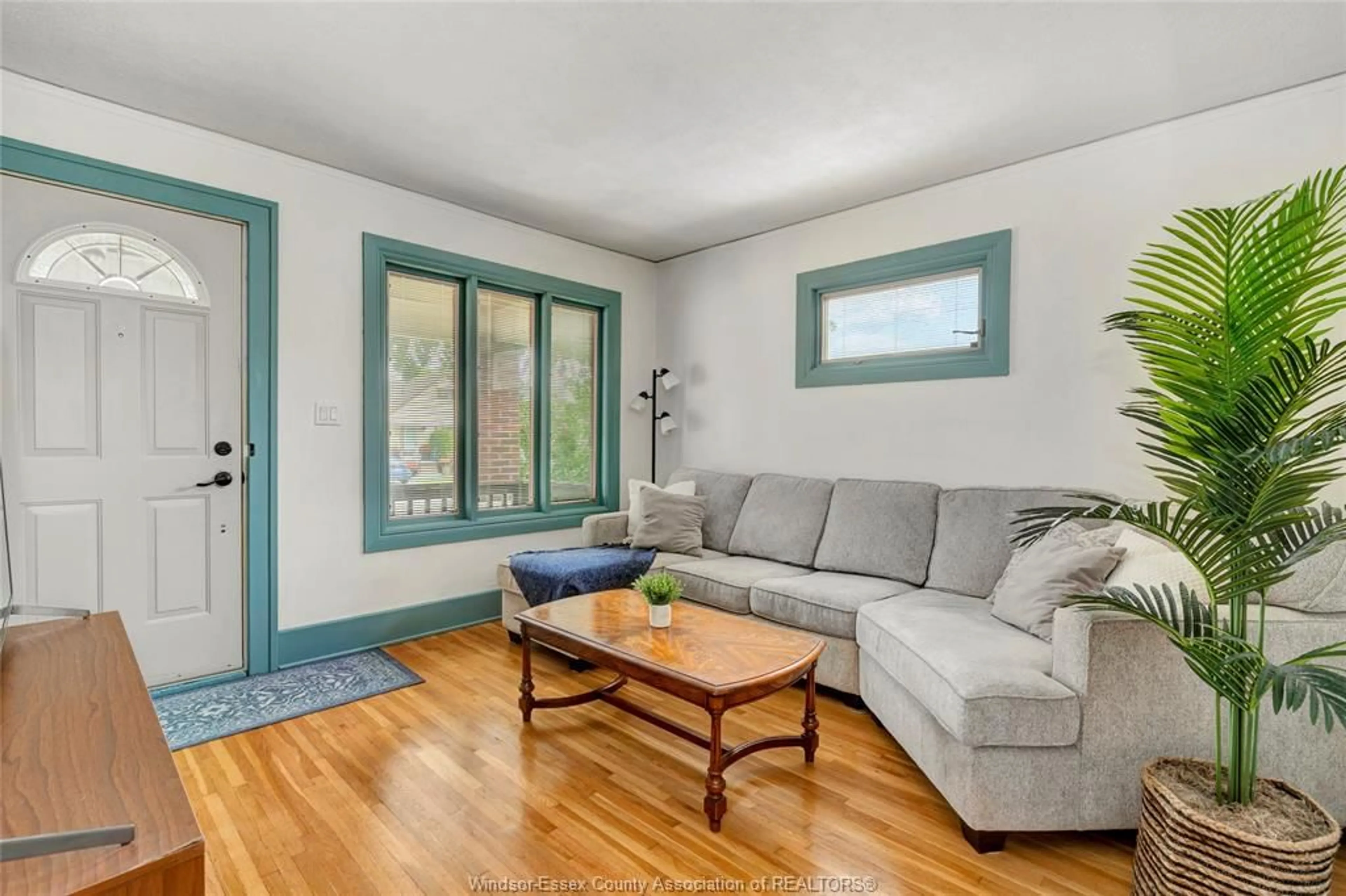 Living room with furniture, wood/laminate floor for 1871 Albert Rd, Windsor Ontario N8W 3X1