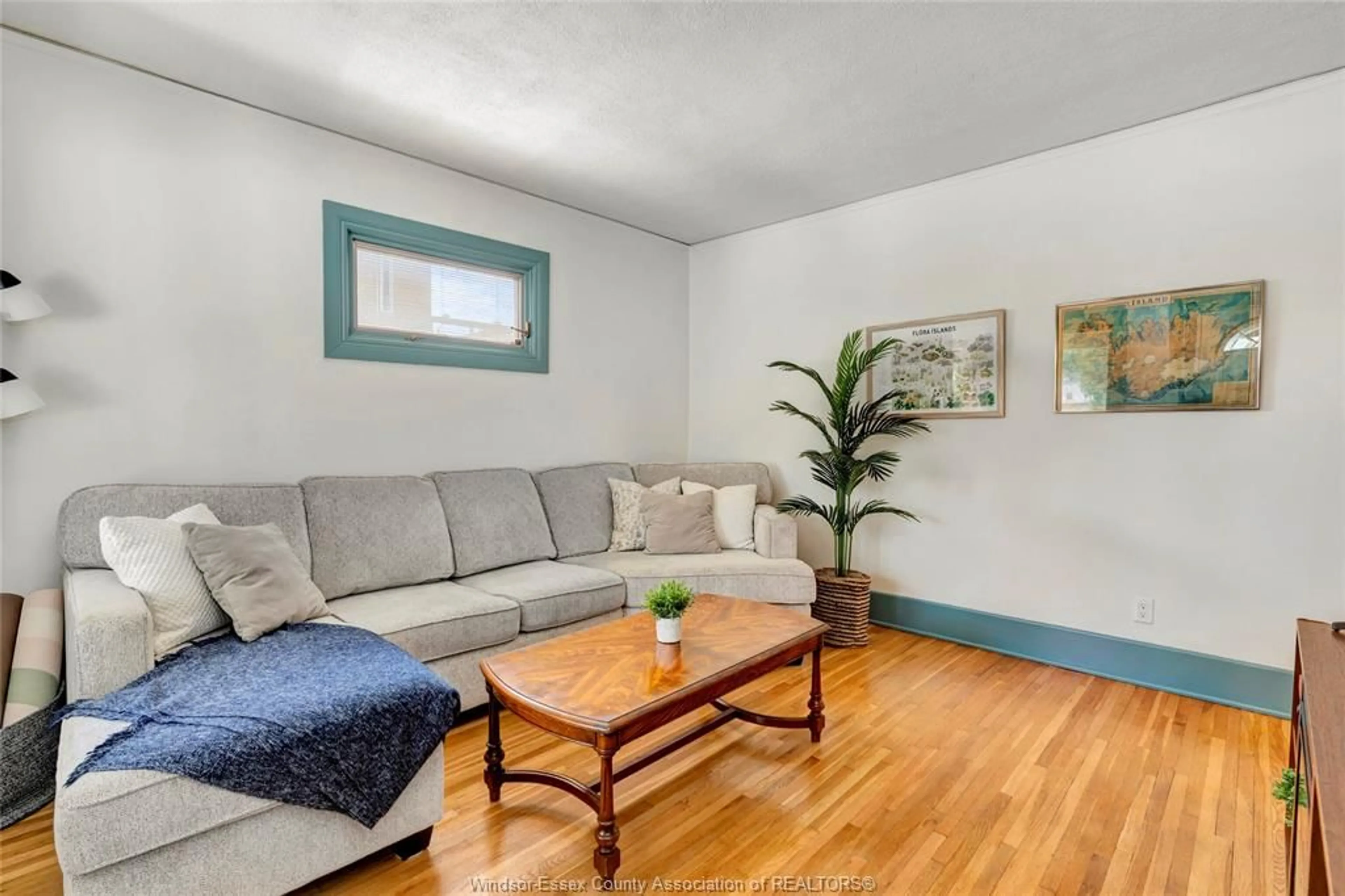 Living room with furniture, wood/laminate floor for 1871 Albert Rd, Windsor Ontario N8W 3X1