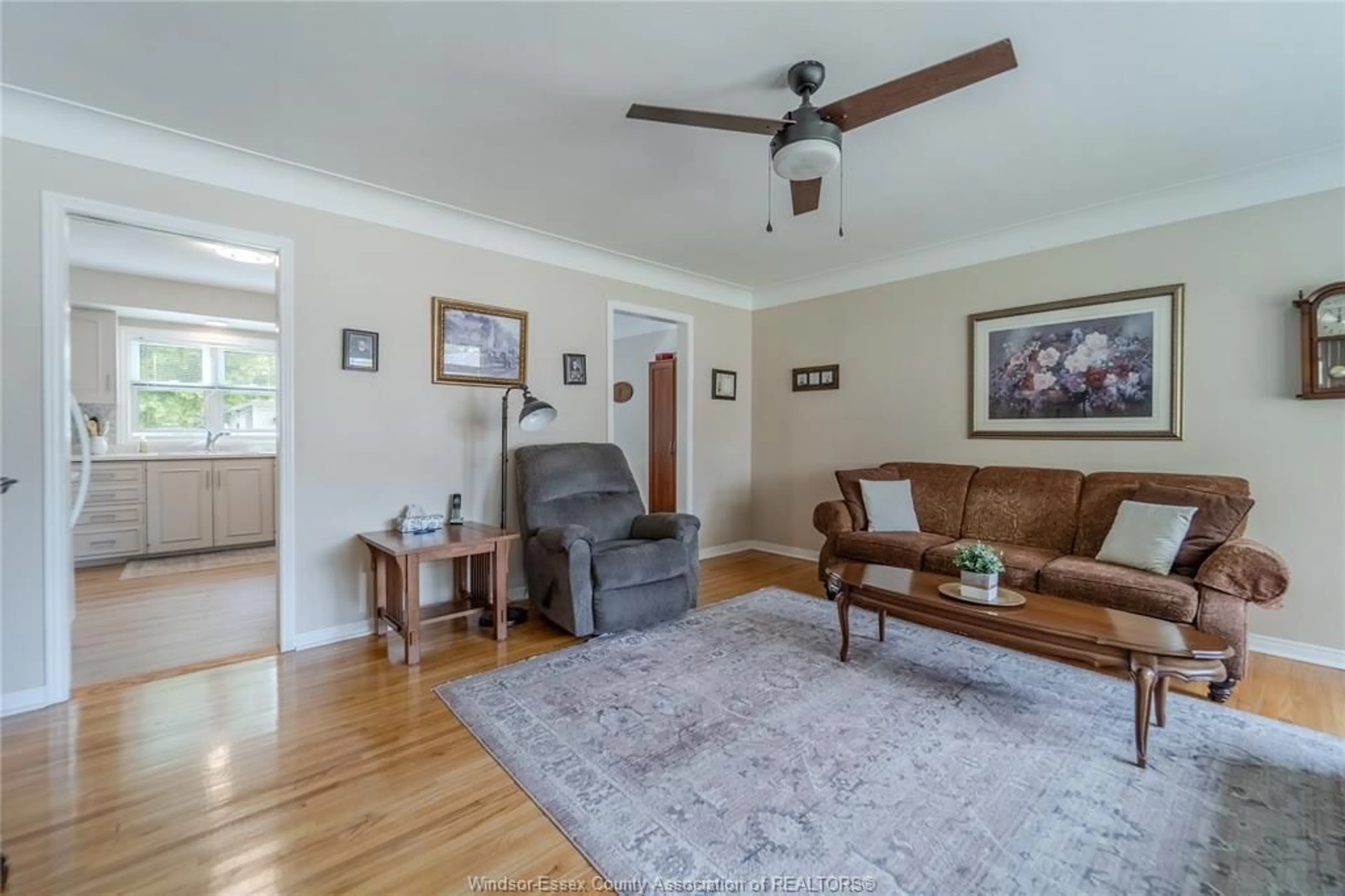 Living room with furniture, wood/laminate floor for 1049 BUCKINGHAM Rd, Windsor Ontario N8S 2E2