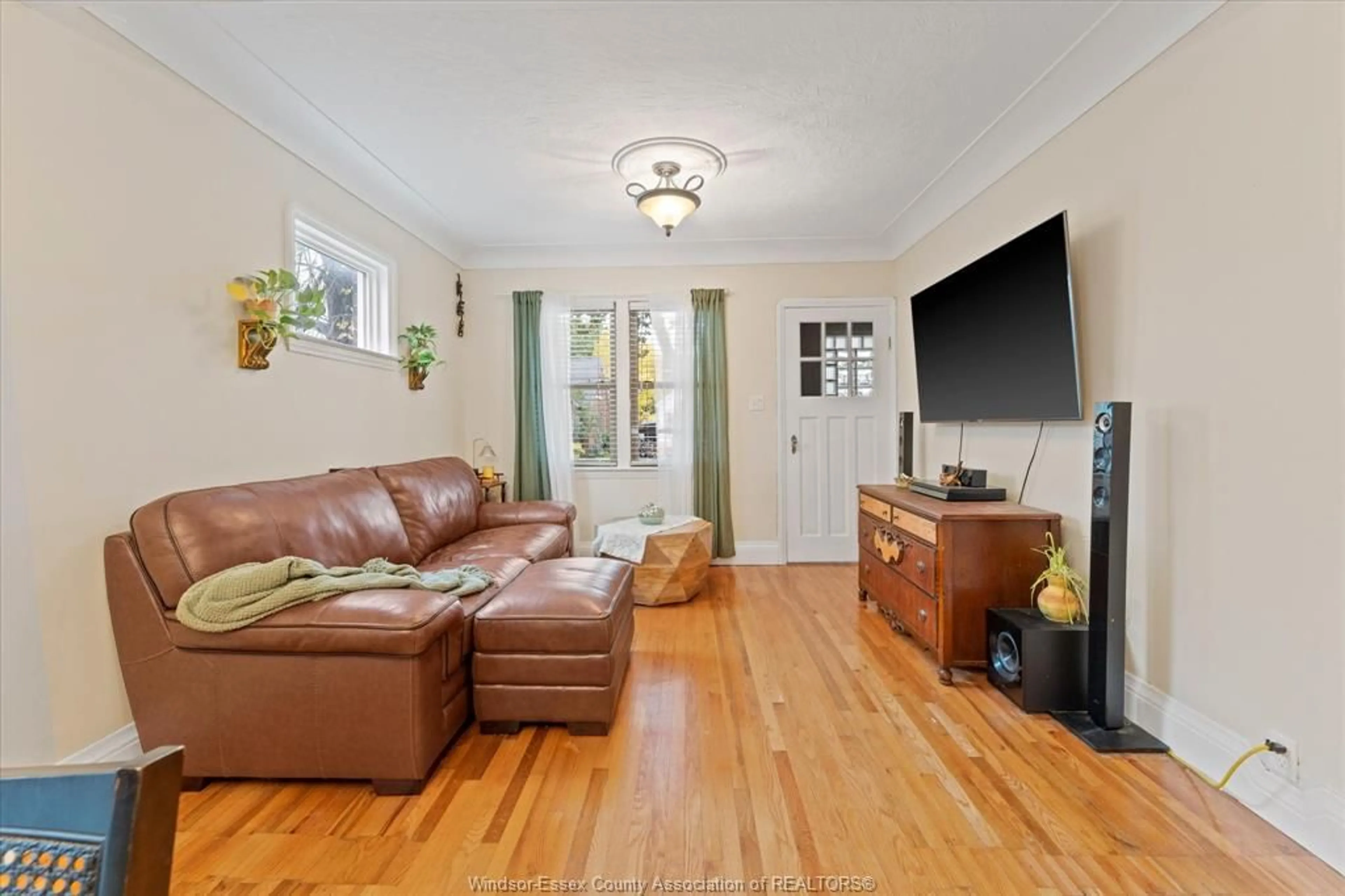 Living room with furniture, wood/laminate floor for 1746 Alexis Rd, Windsor Ontario N8Y 4P5