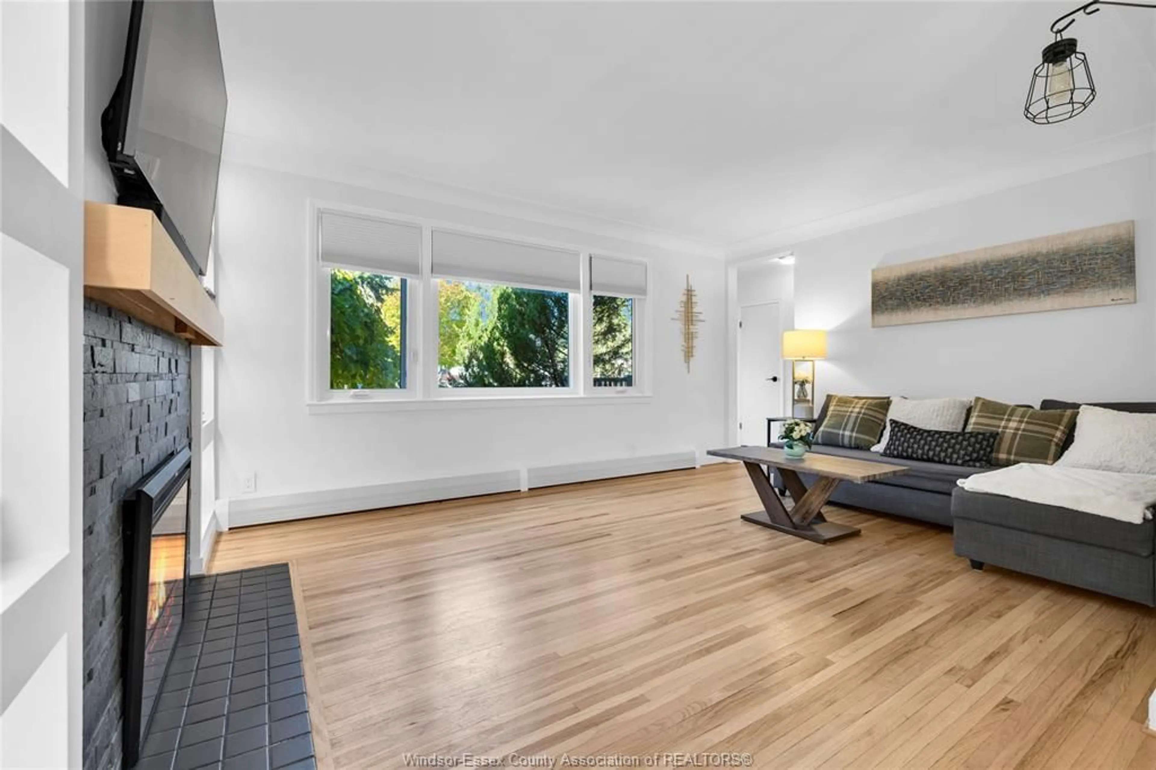 Living room with furniture, wood/laminate floor for 7565 St. Rose, Windsor Ontario N8S 1V6