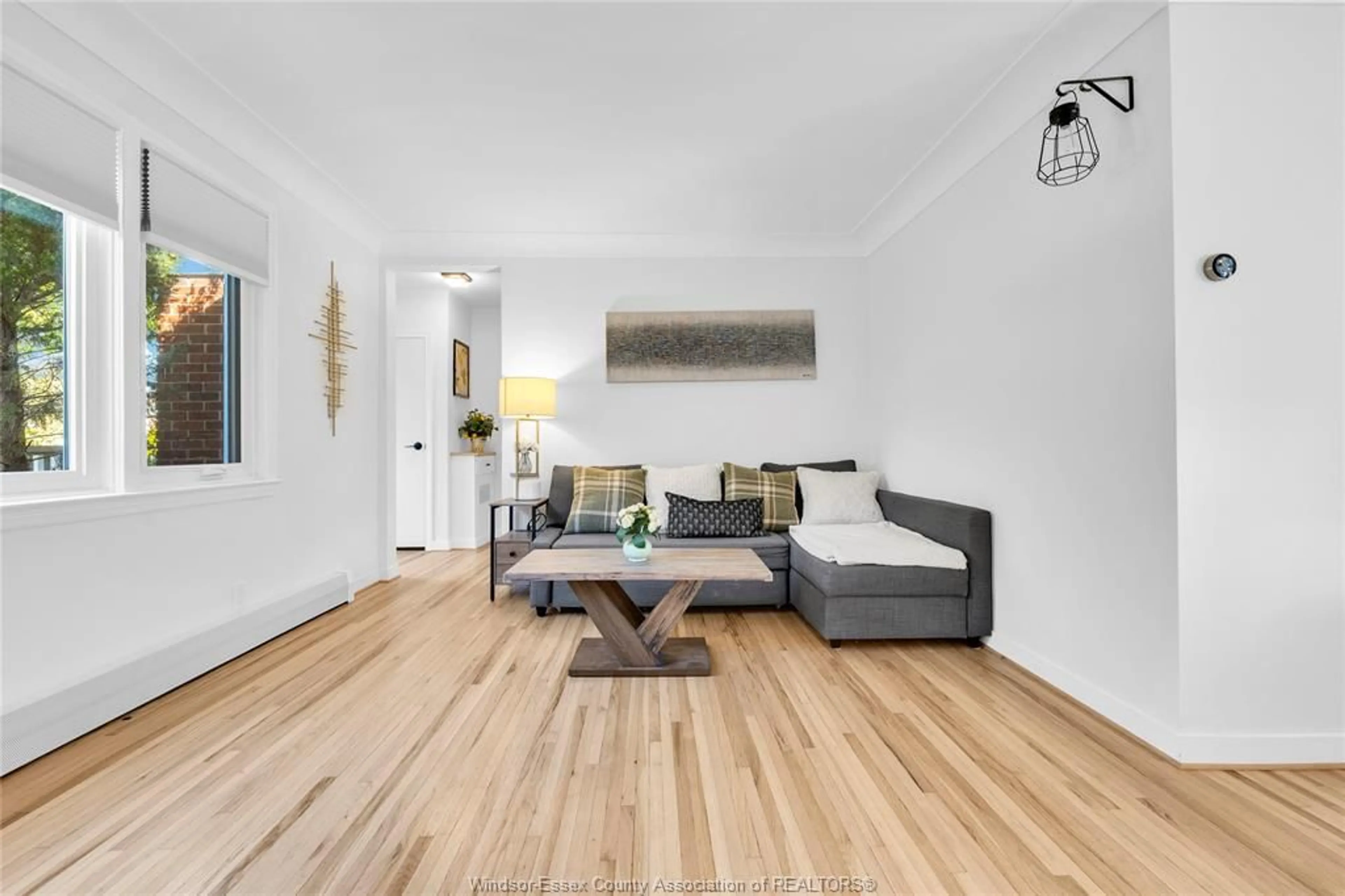 Living room with furniture, wood/laminate floor for 7565 St. Rose, Windsor Ontario N8S 1V6
