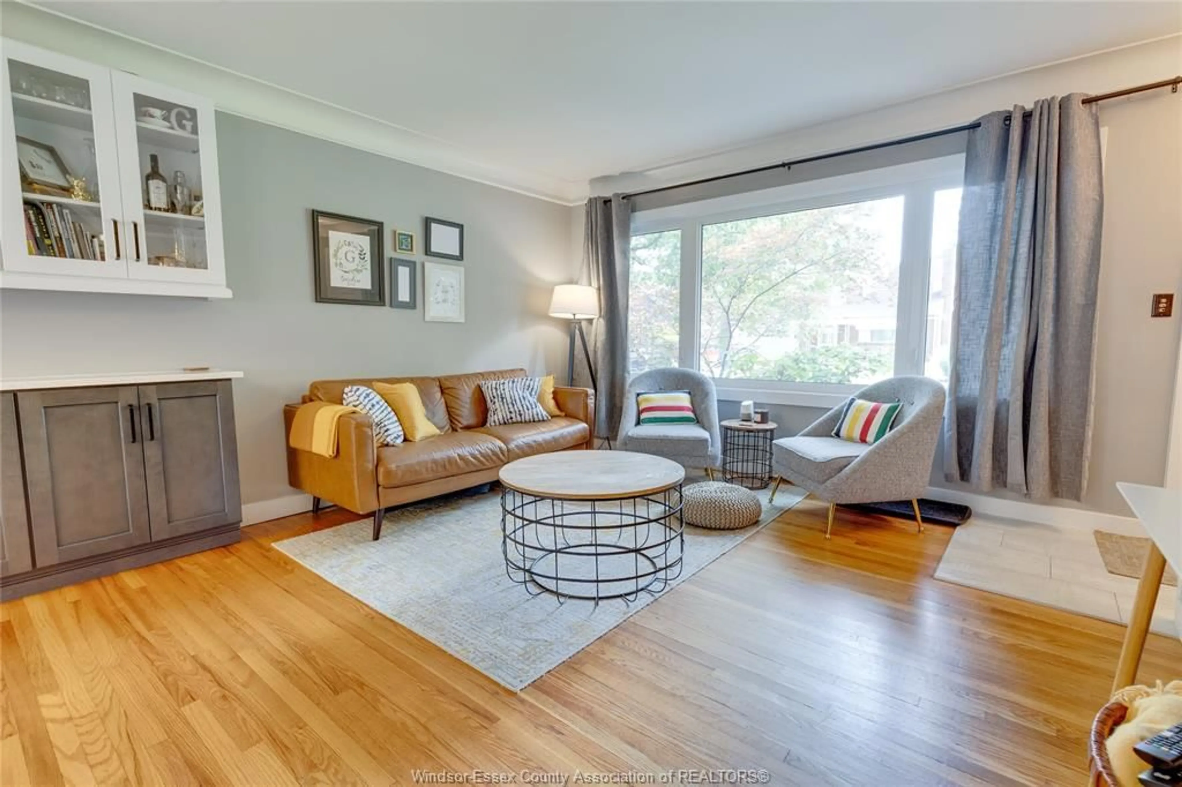 Living room with furniture, wood/laminate floor for 3035 RADISSON, Windsor Ontario N9E 1Y4
